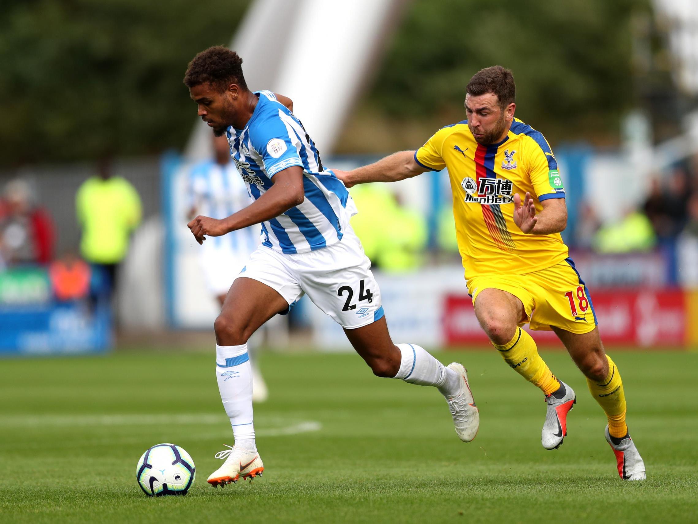 Steve Mounie rushes to get away from James McArthur