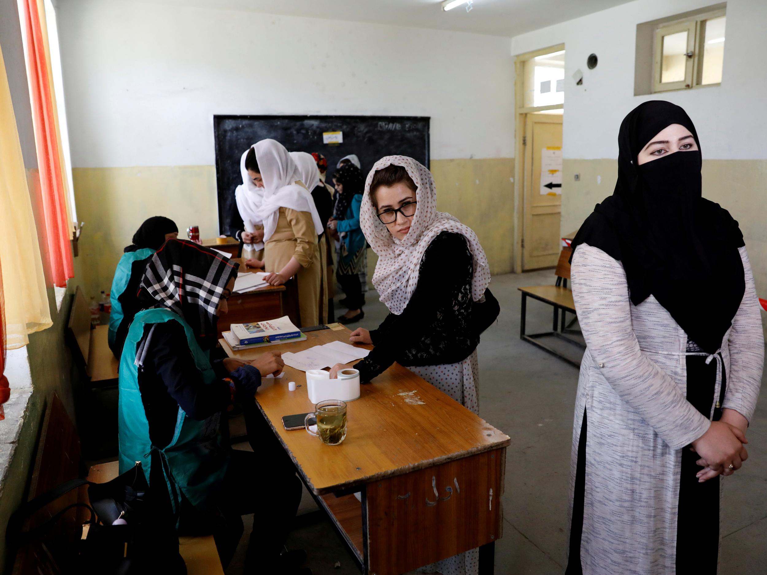 Afghan women arrive at a voter registration centre to register for the upcoming parliamentary and district council elections in Kabul, Afghanistan