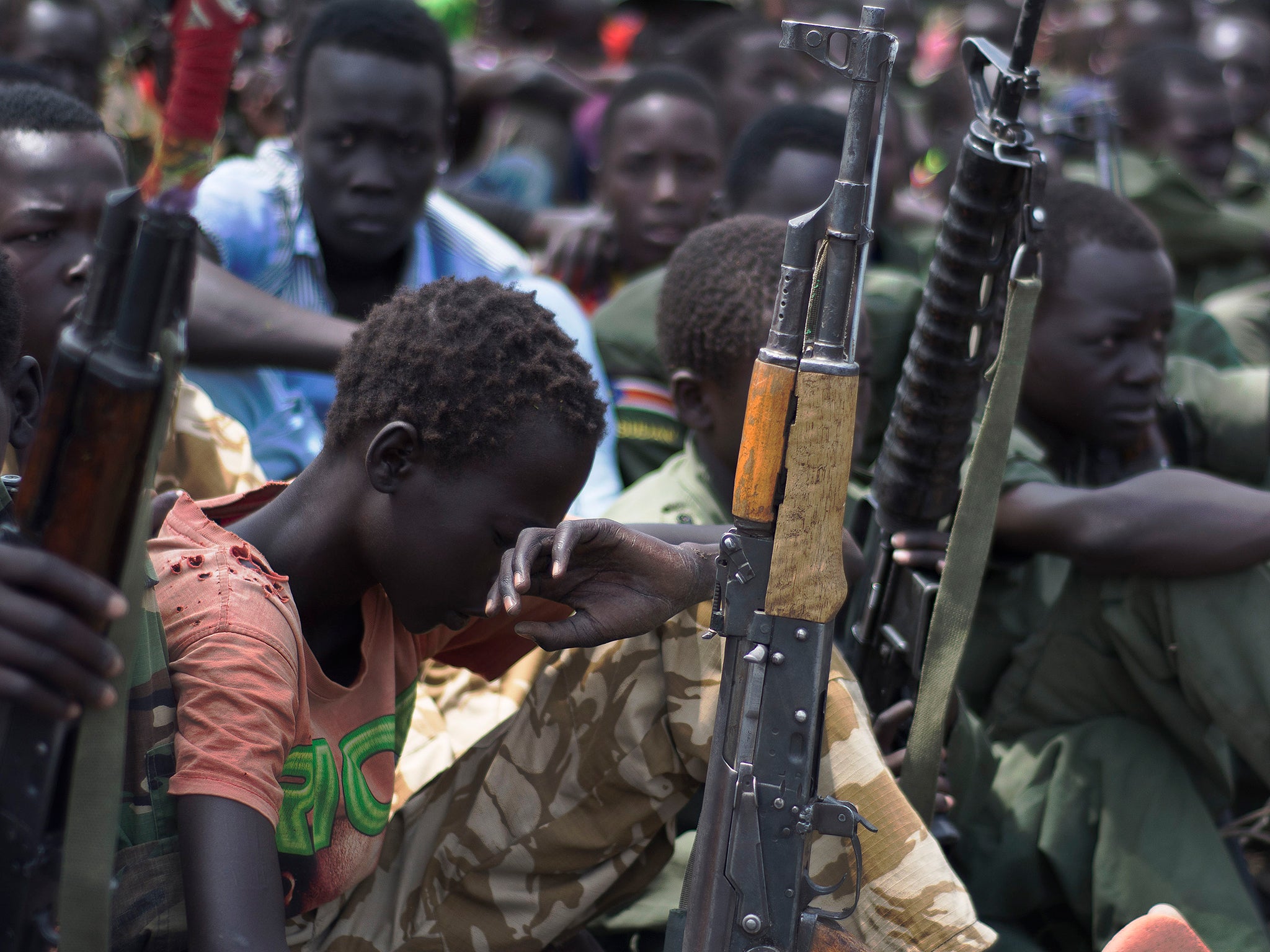 Freed child soldiers with their rifles