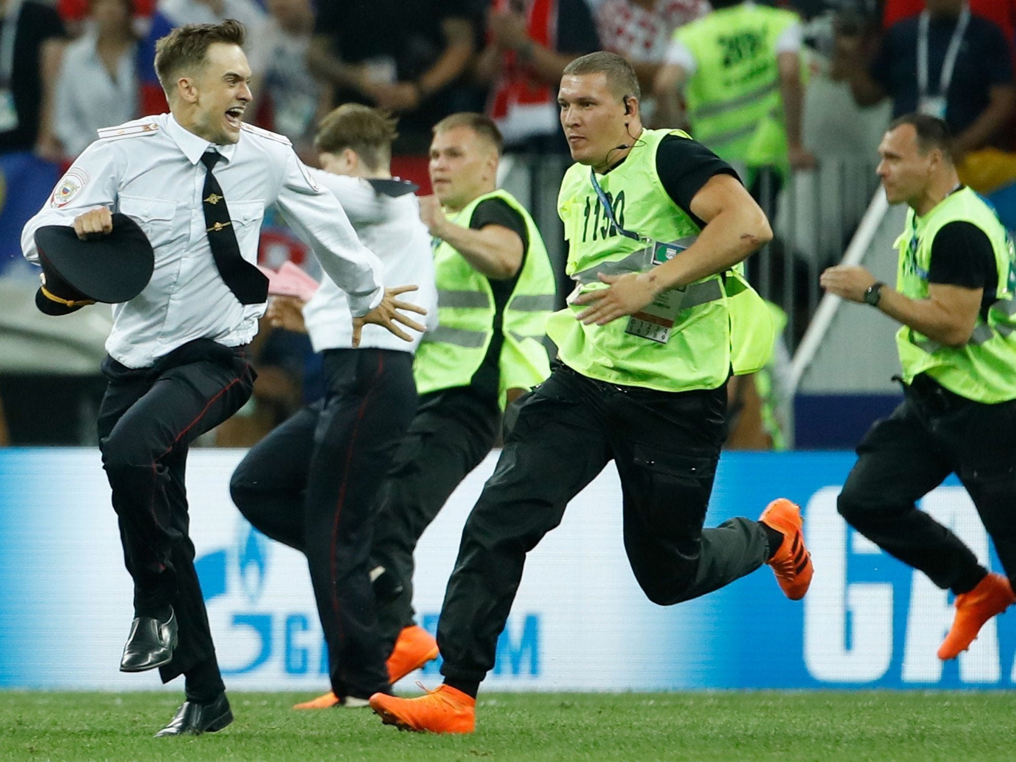 Stewards chase Pussy Riot member Pyotr Verzilov during a pitch invasion protest at the 2018 World Cup Final in Moscow