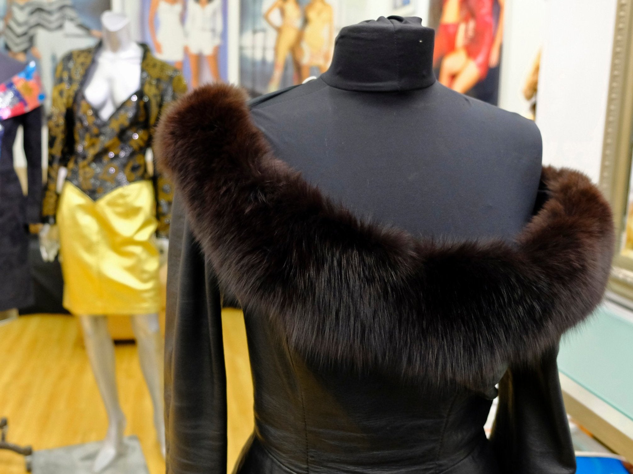 A vintage fox trimmed leather dress displayed in the basement of a store in San Francisco