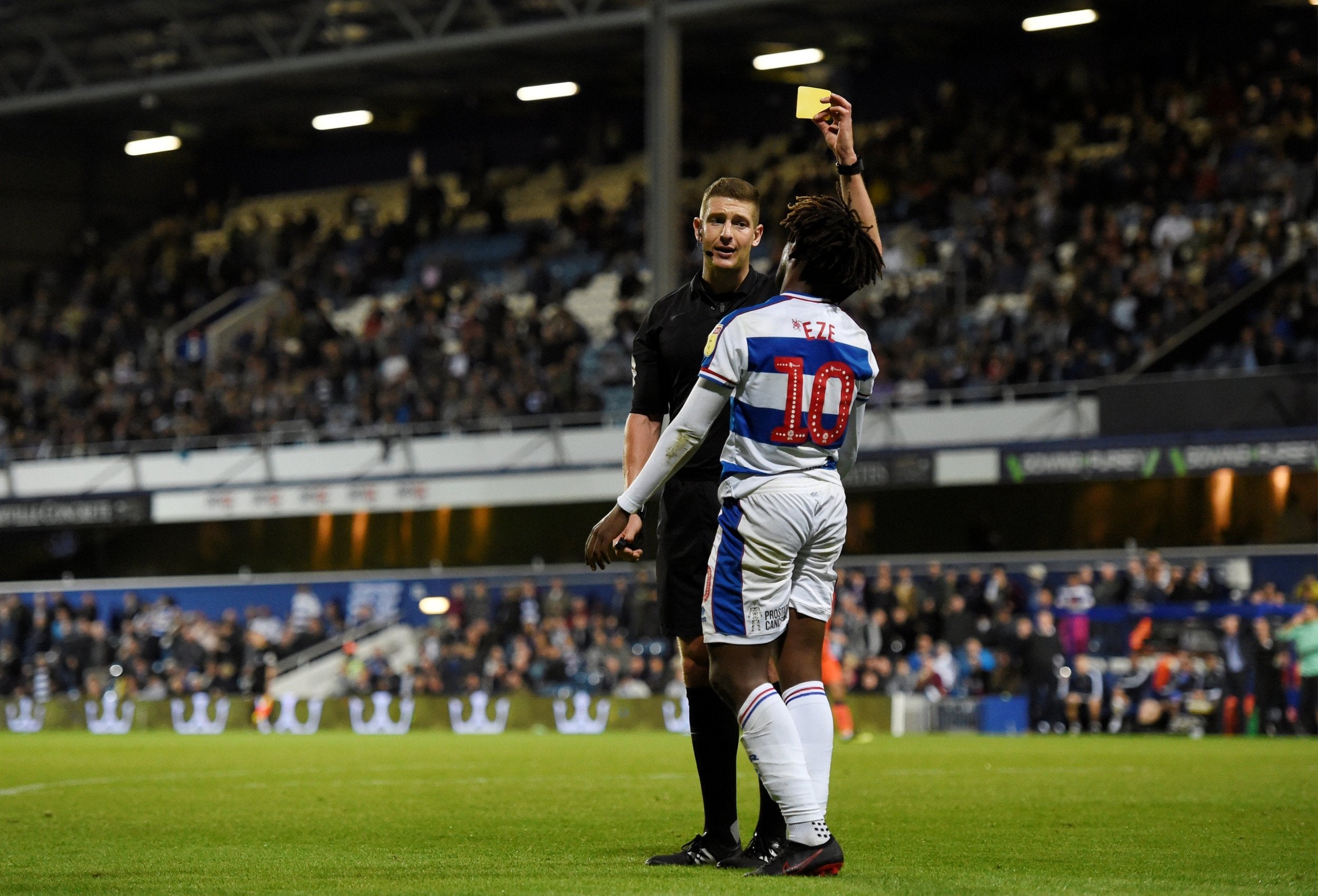 Eberechi Eze is booked for diving by referee Robert Jones