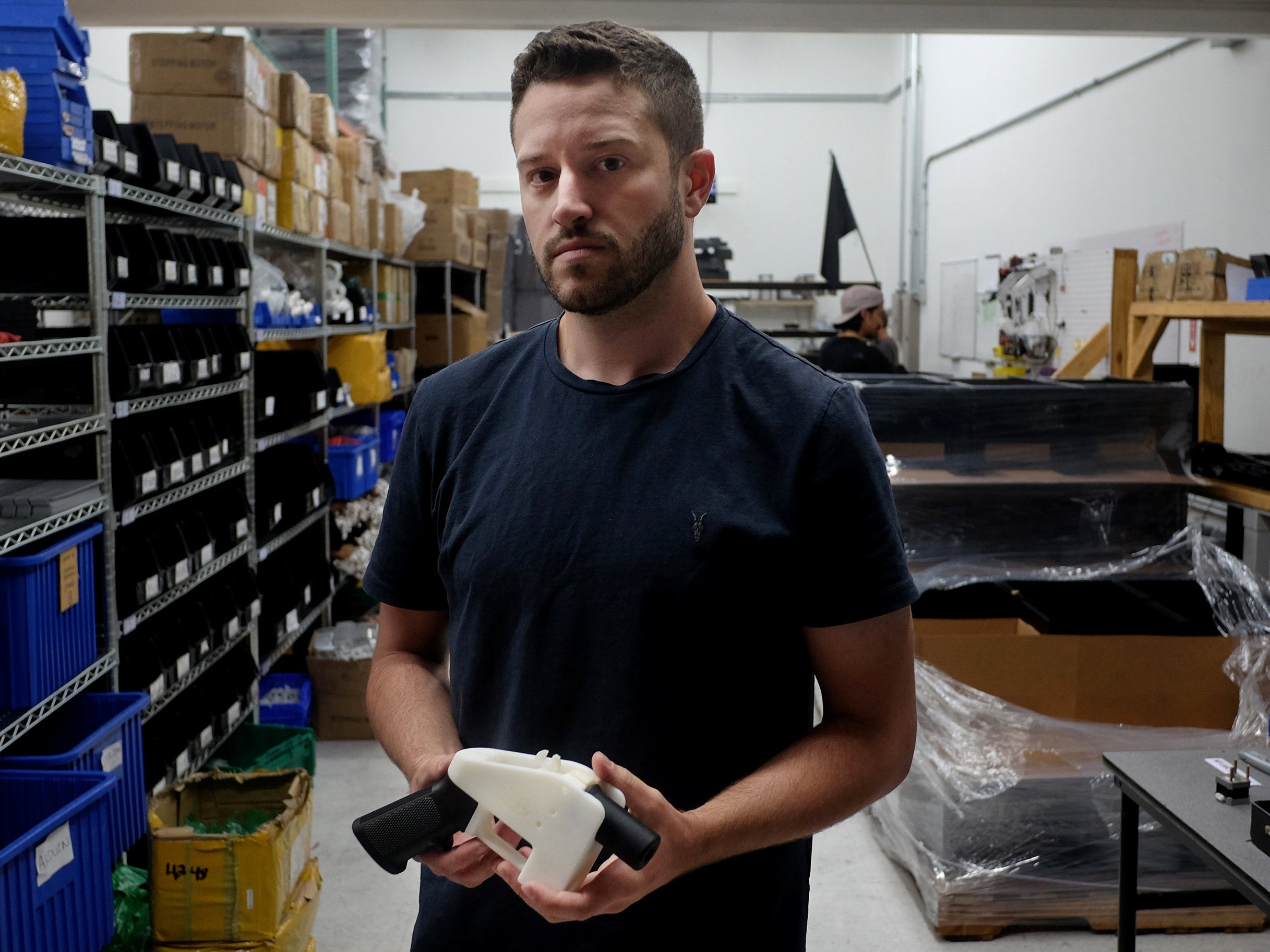 Cody Wilson with an example of a 3-D printed gun, called the 'Liberator', which his company Defence Distributed designed at his factory in Austin, Texas