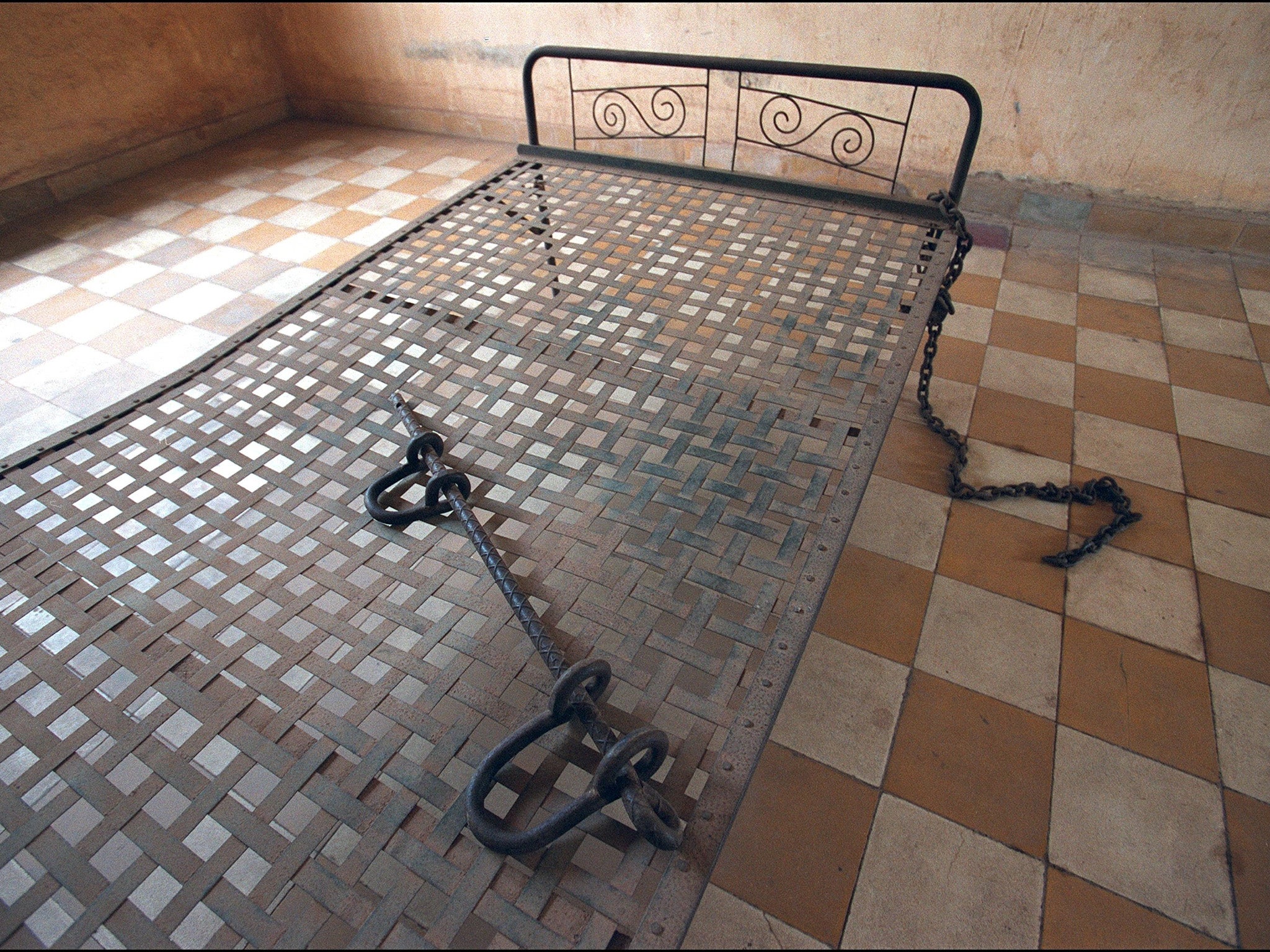 An iron bed in one of the torture rooms at S-21: outside there are many bodies yet to be excavated