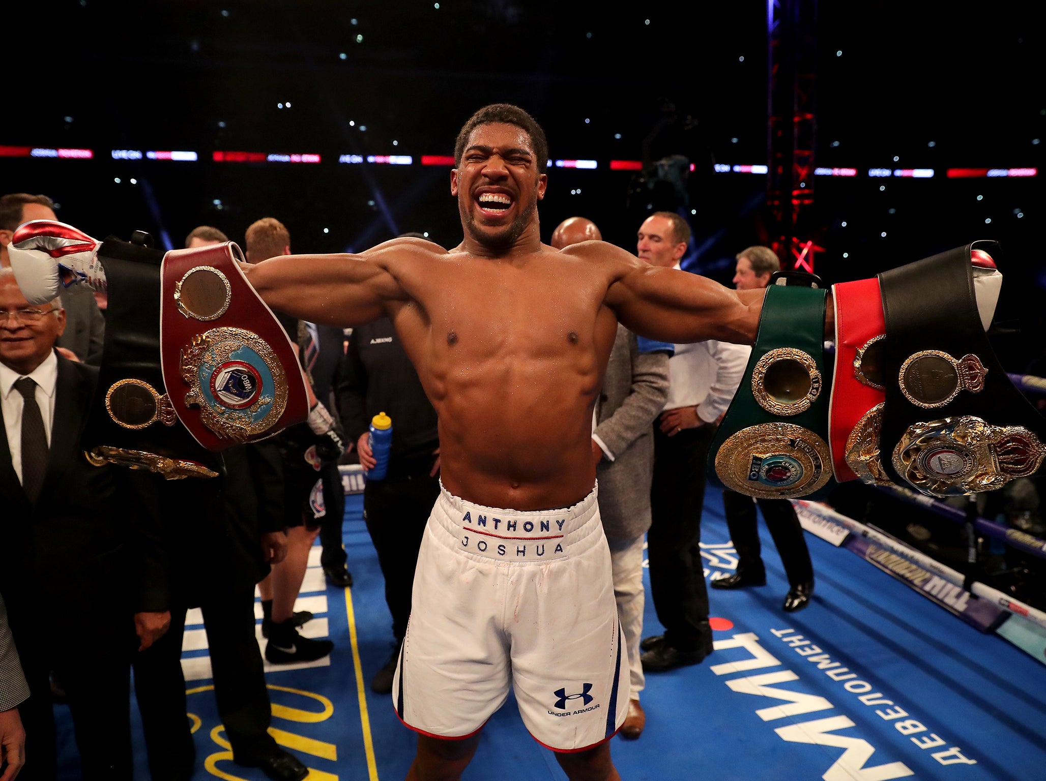 Joshua celebrates with the IBF, WBA Super, WBO &amp; IBO belts