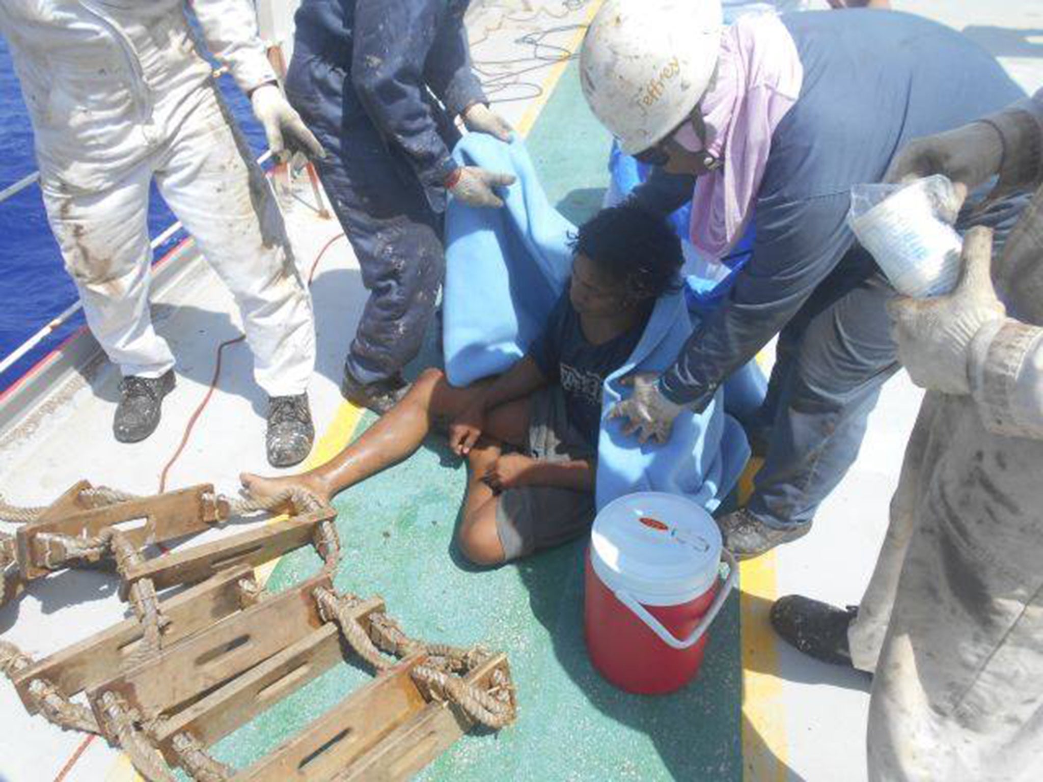 Aldi Novel Adilang shortly after he was pulled onto the MV Arpeggio, by the ship's crew.