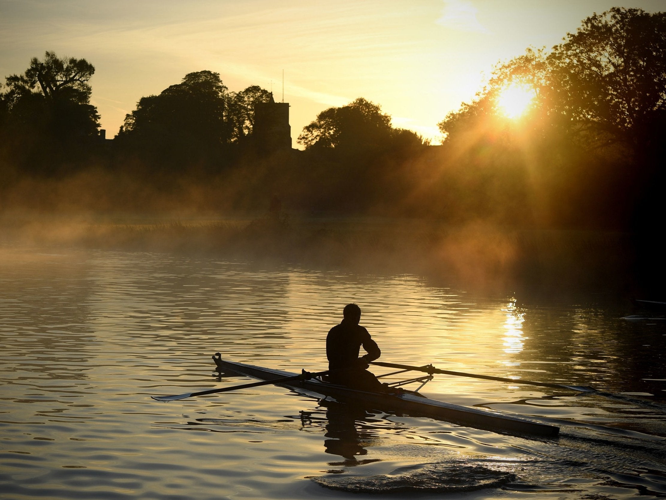 A rower trains on the River Cam in Cambridge at sunrise on Tuesday as early morning mist hangs over the water