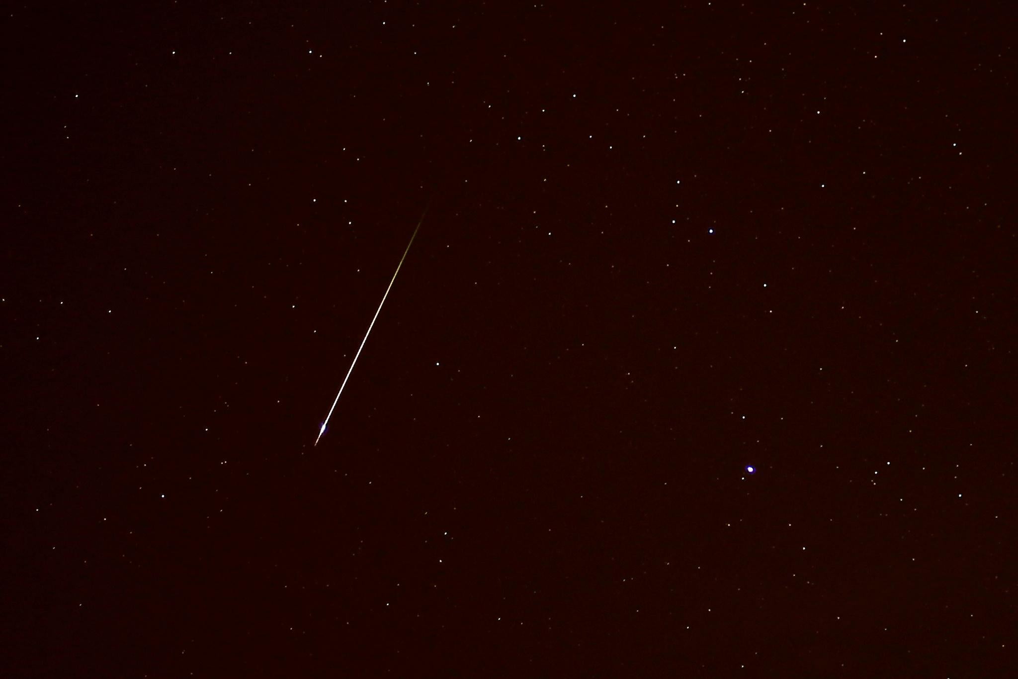 A meteor streaks past the Canis Minor constellation in the night sky during the annual Orionid meteor shower in Ronda, near Malaga, Spain