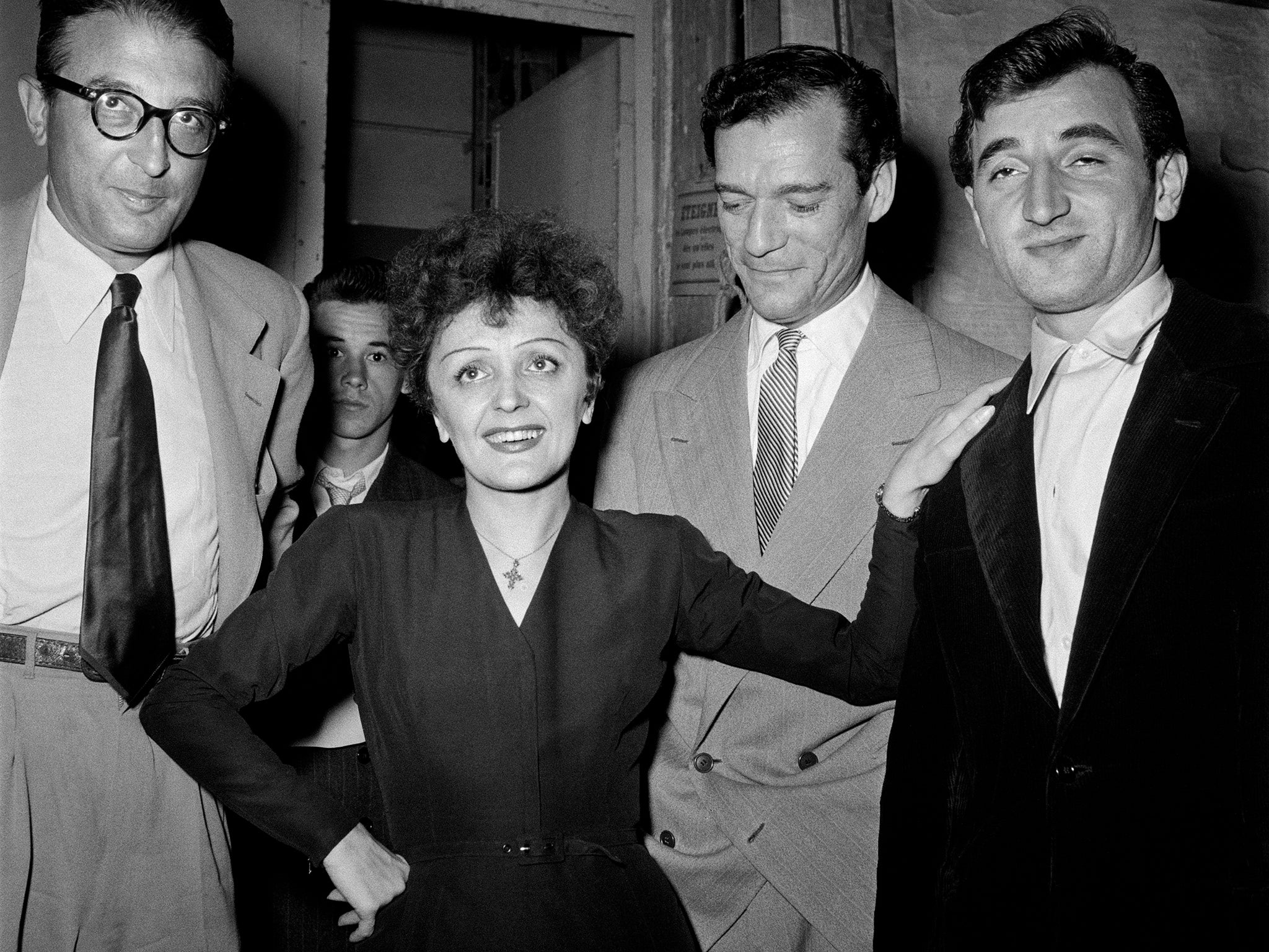 Aznavour, right, with US actor Eddie Constantine, Edith Piaf and French composer Michel Emer in 1950 in Paris (Getty)