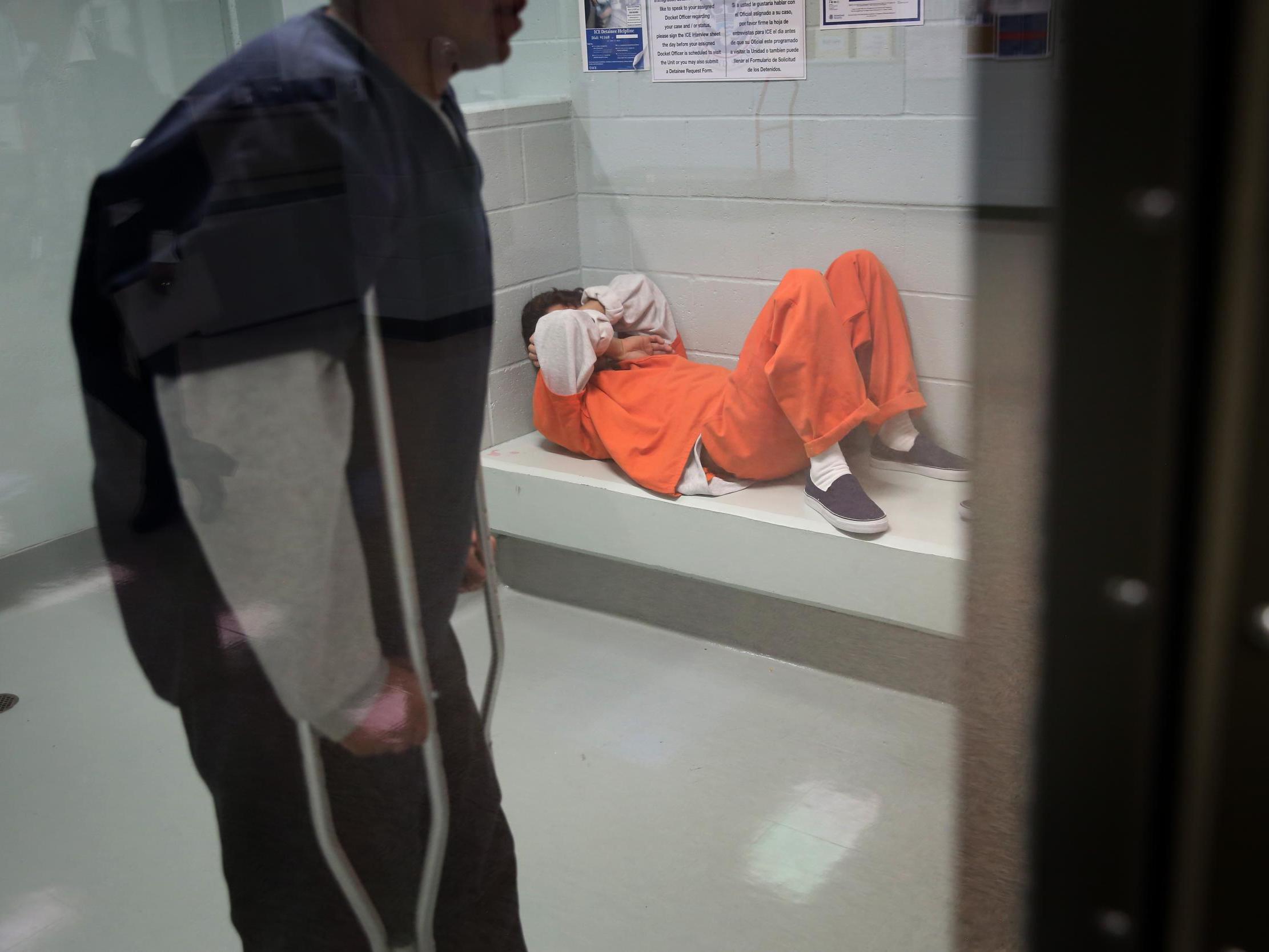 Immigrants wait in a processing cell at the Adelanto Detention Facility on November 15, 2013 in Adelanto, California.