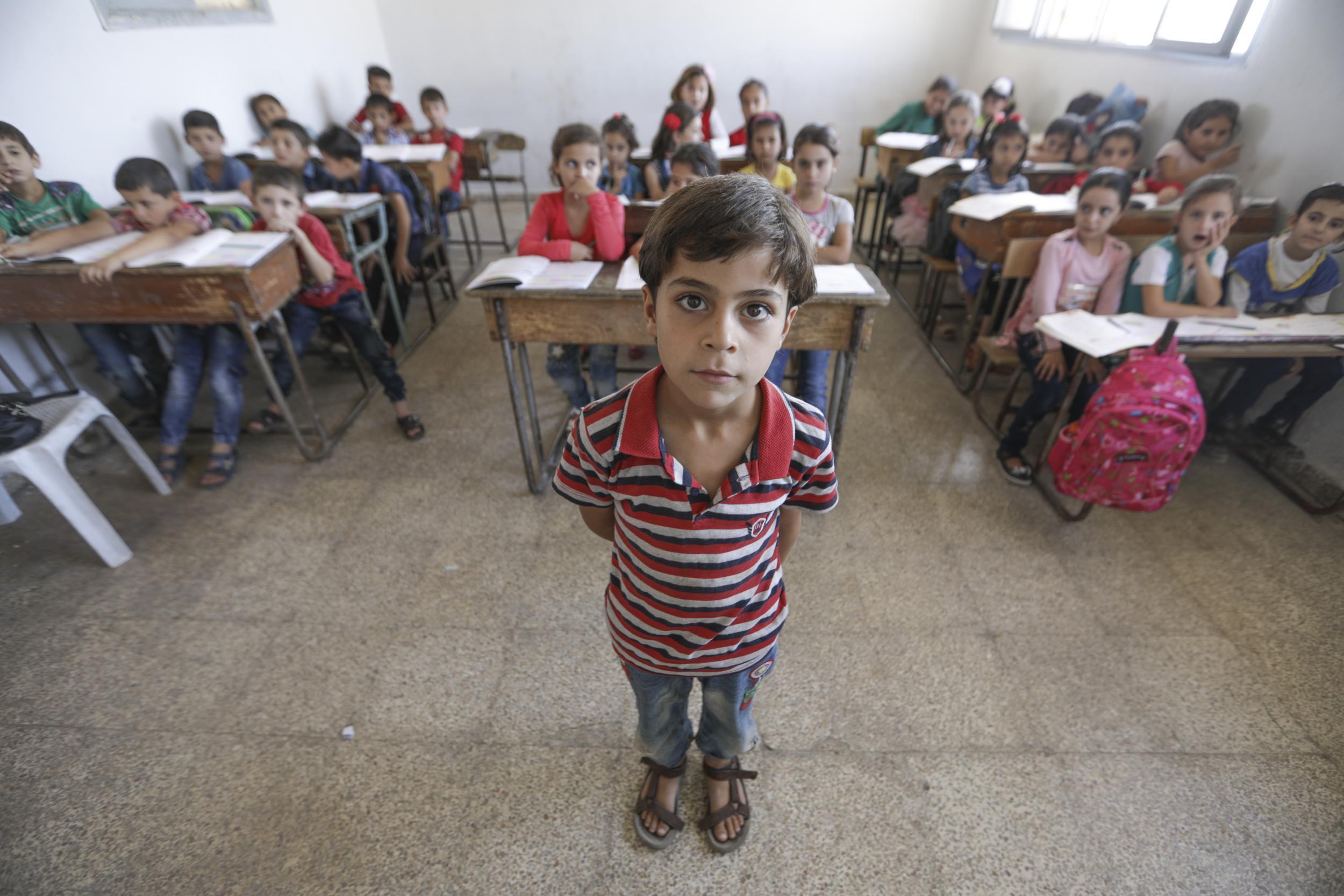 Abdullah, eight, at school in Idlib, Syria