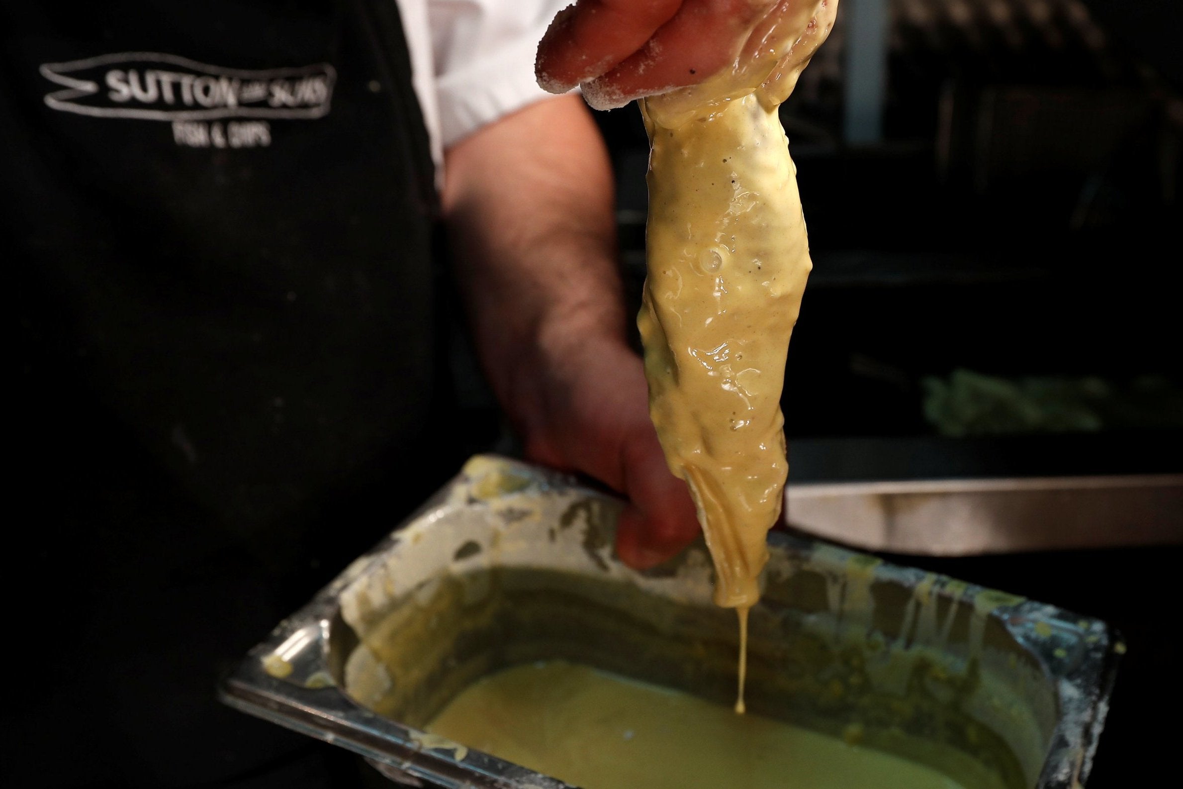 Banana blossom is covered in batter before cooking.