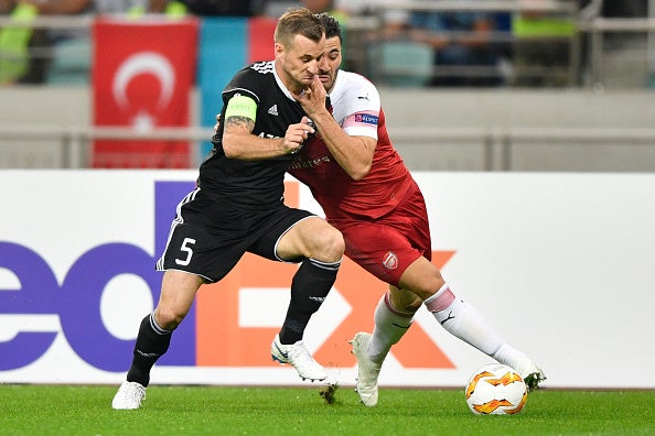 Sead Kolasinac vies for the ball with Maksim Medvedev