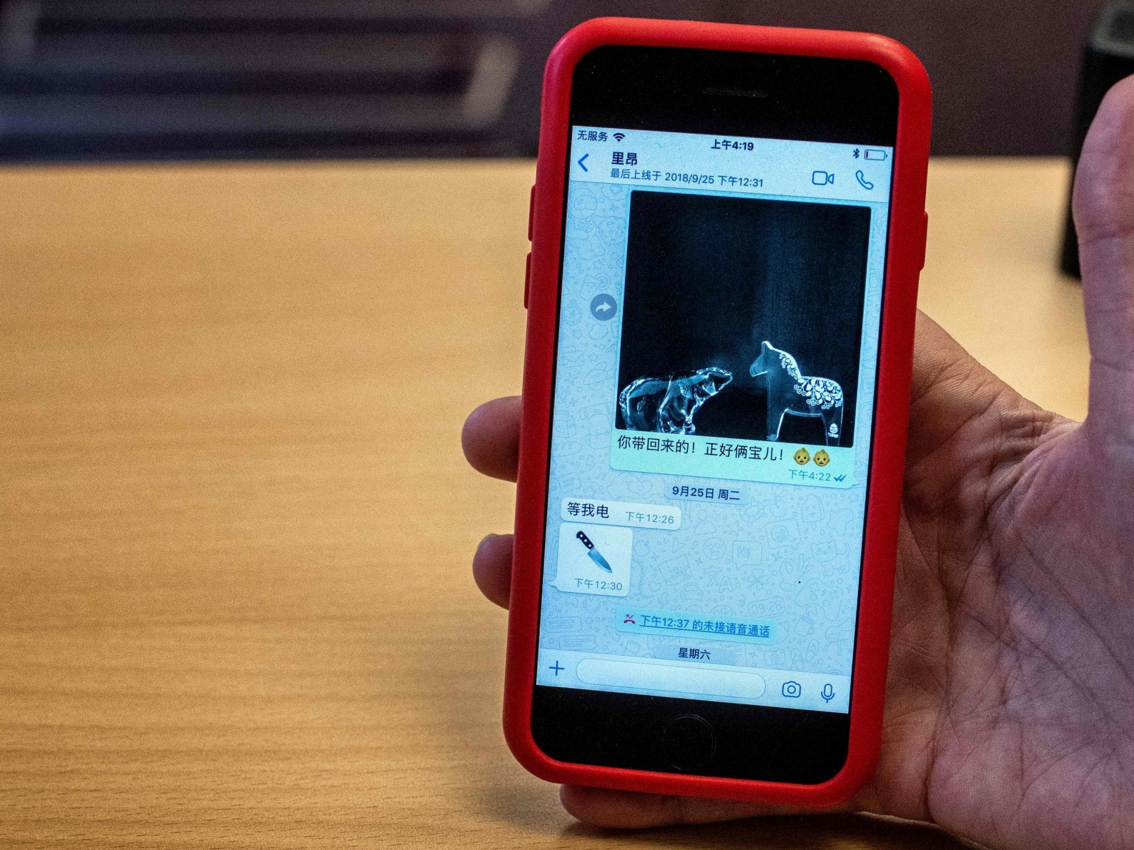 A journalist holds the mobile phone of Grace Meng, the wife of the missing Interpol president Meng Hongwey, showing their last message exchange