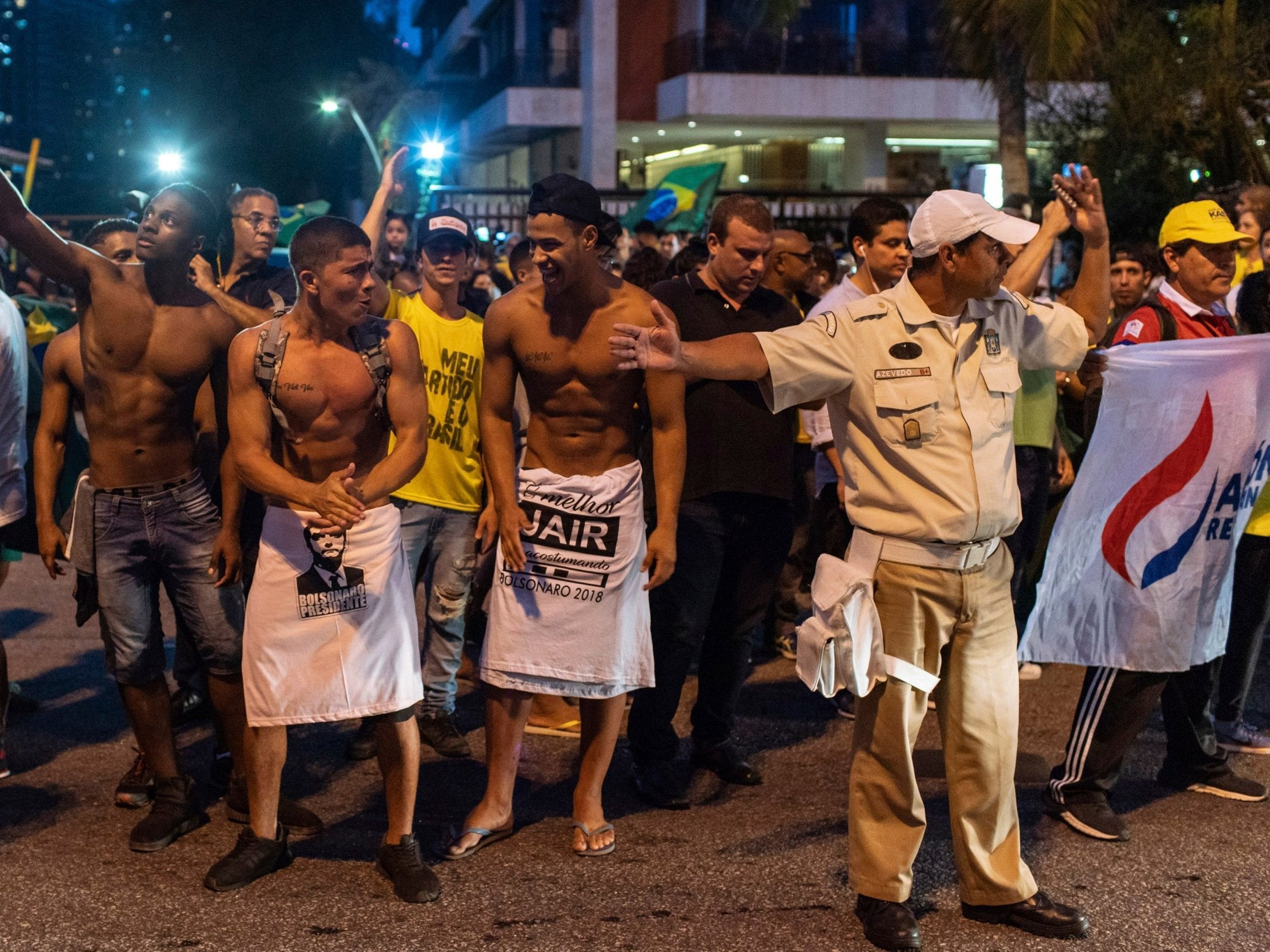 Supporters of Jair Bolsonaro celebrate his election lead in front of his house in Rio de Janeiro
