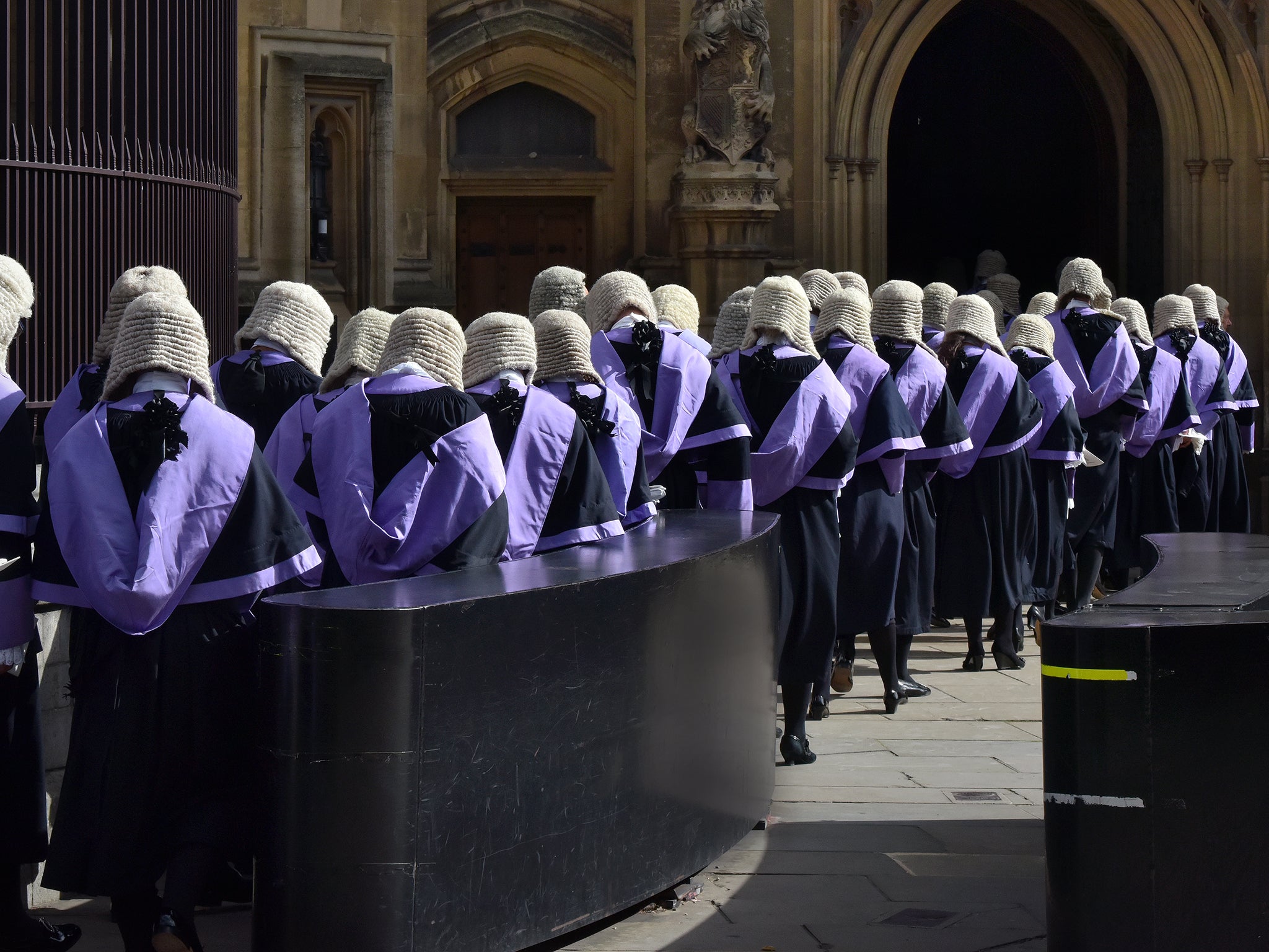 Judges wearing traditional wigs and gowns in procession at Westminster.