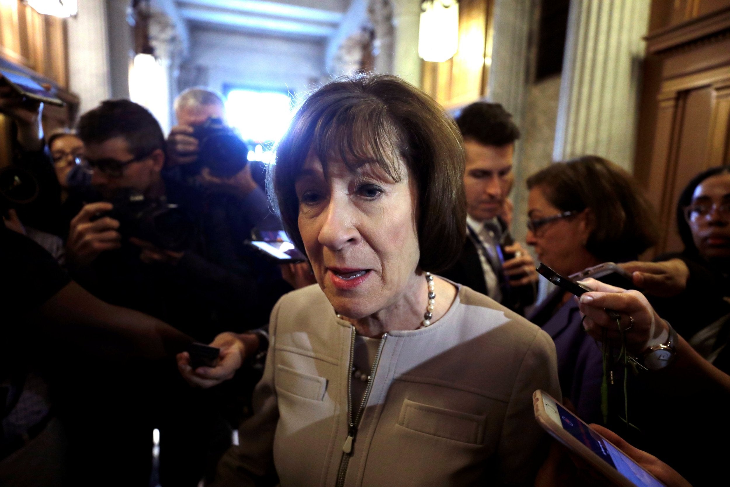 US Senator Collins talks with reporters as she leaves the floor of the Senate after announcing that she will vote to confirm Supreme Court nominee judge Brett Kavanaugh