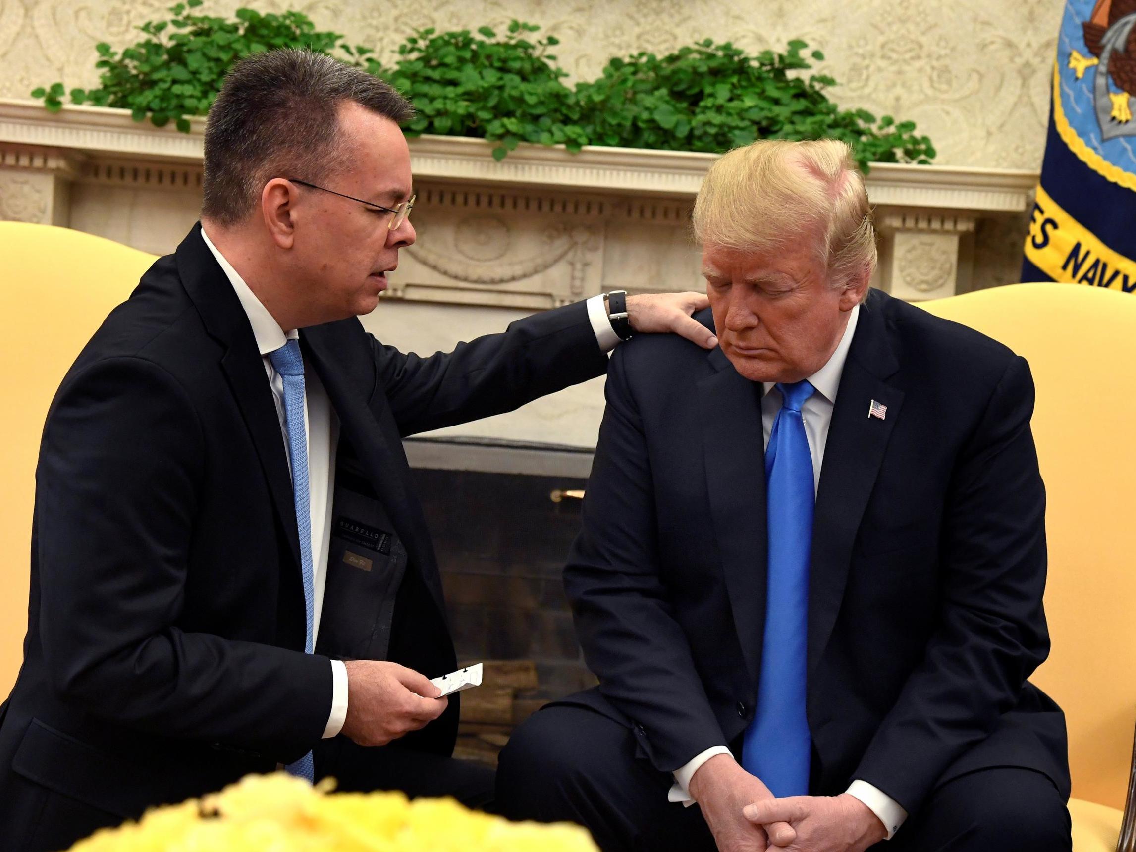 Mr Brunson knelt and prayed for Mr Trump in the Oval Office