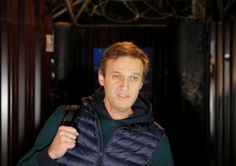 Russian opposition leader Alexei Navalny walks out following his release from jail