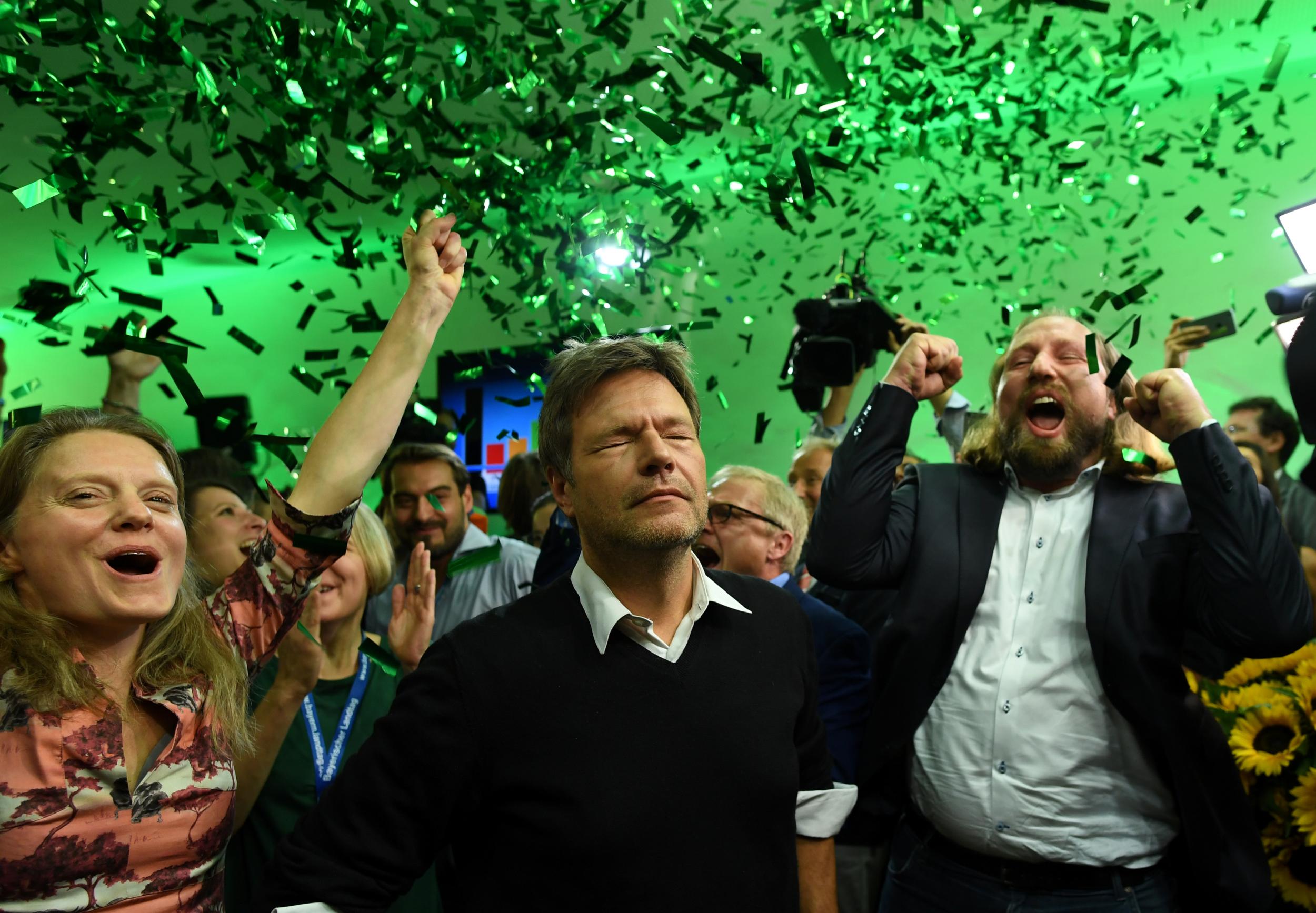 Leaders of the German Green party (Die Gruenen), Henrike Hahn, Robert Habeck and Anton Hofreiter react after to the first exit polls in the Bavarian state elections in Munich