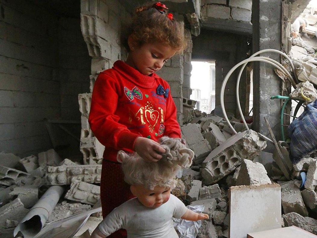 A child stands in the rubble of damaged buildings in Raqqa last month