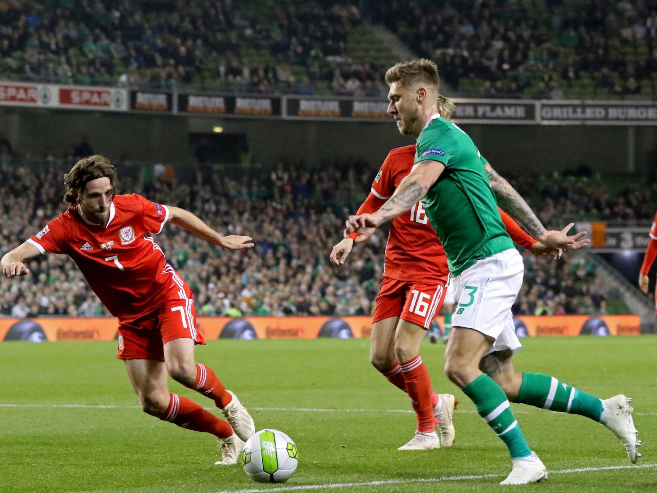 Jeff Hendrick runs at Wales midfielder Joe Allen