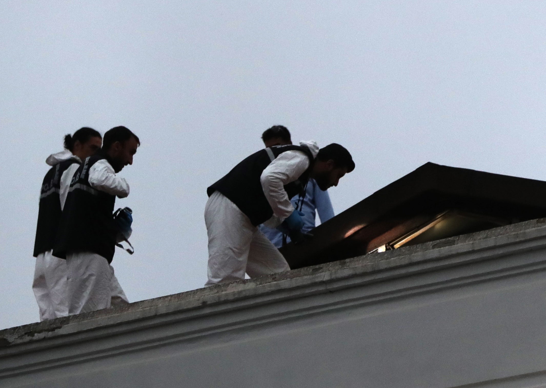 Turkish forensic police officers work on the roof of the residence of the Saudi consul in Istanbul