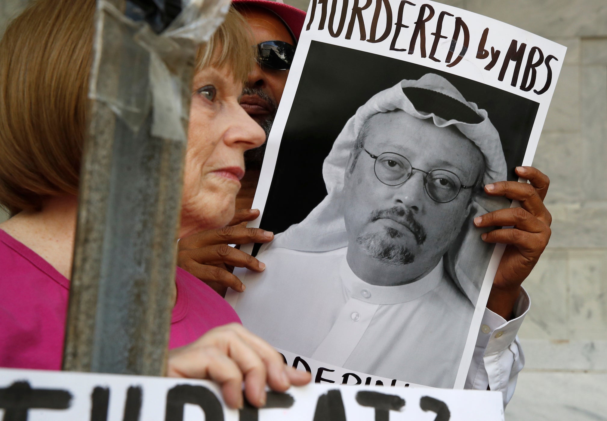 People hold signs during a protest at the Embassy of Saudi Arabia about the disappearance of Saudi journalist Jamal Khashoggi, in Washington on 10 October