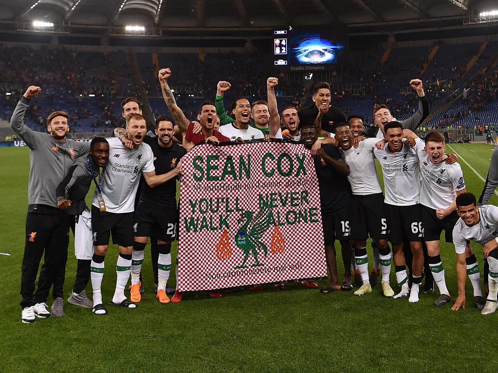 Liverpool players hold a message of support for Sean Cox in 2018