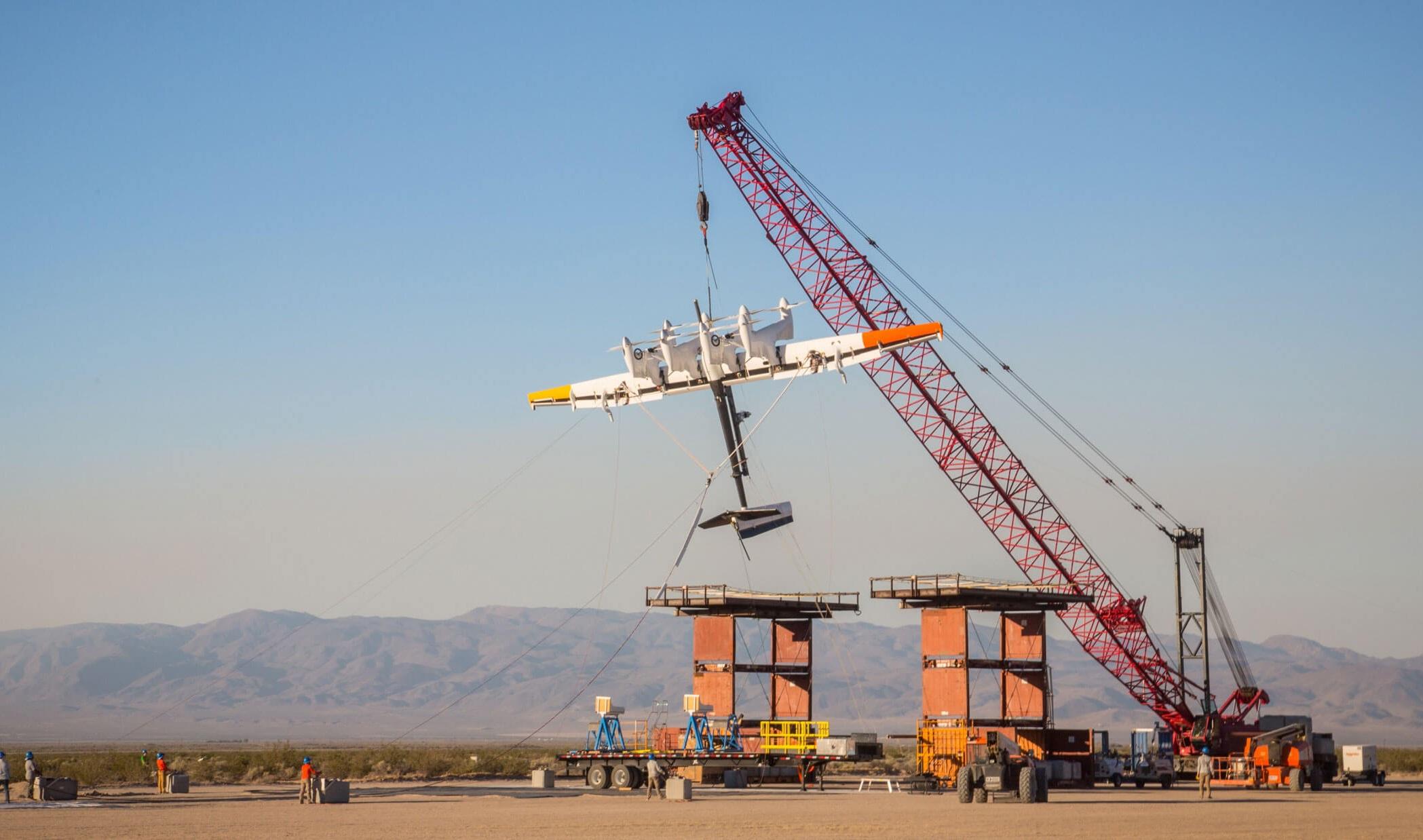 A prototype of the Makani kite is hoisted by a crane