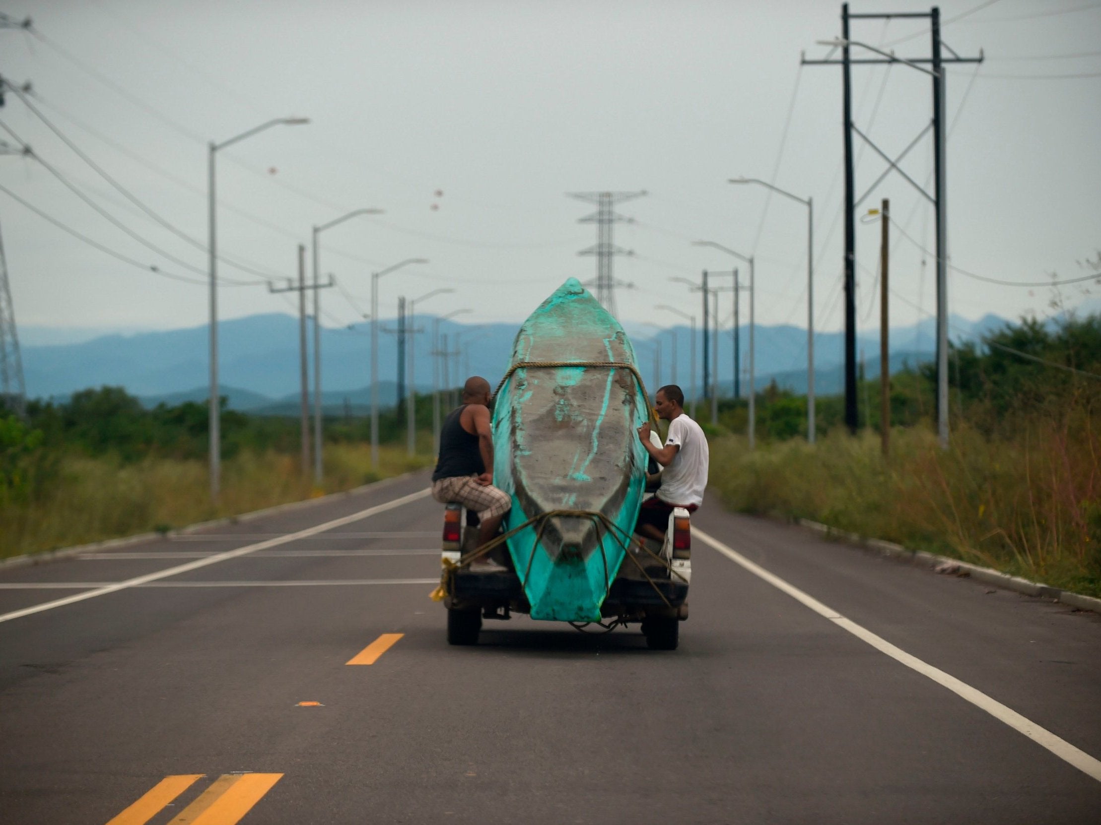 Men transport a boat on a truck in Teacapan, Sinaloa state before the arrival of Hurricane Willa