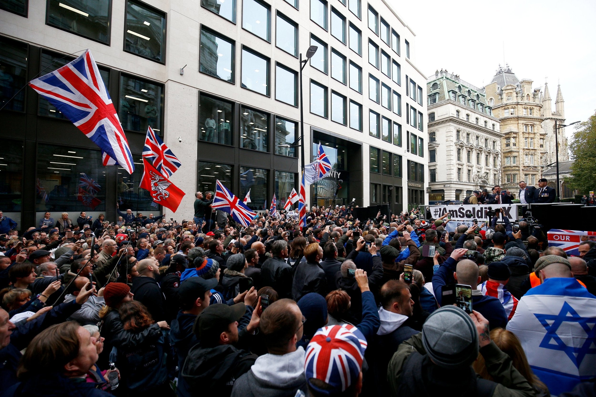 Stephen Yaxley-Lennon, who goes by the name Tommy Robinson, speaks to supporters as he arrives to face contempt of court charges at the Old Bailey in London, on 23 October ( REUTERS/Henry Nicholls)