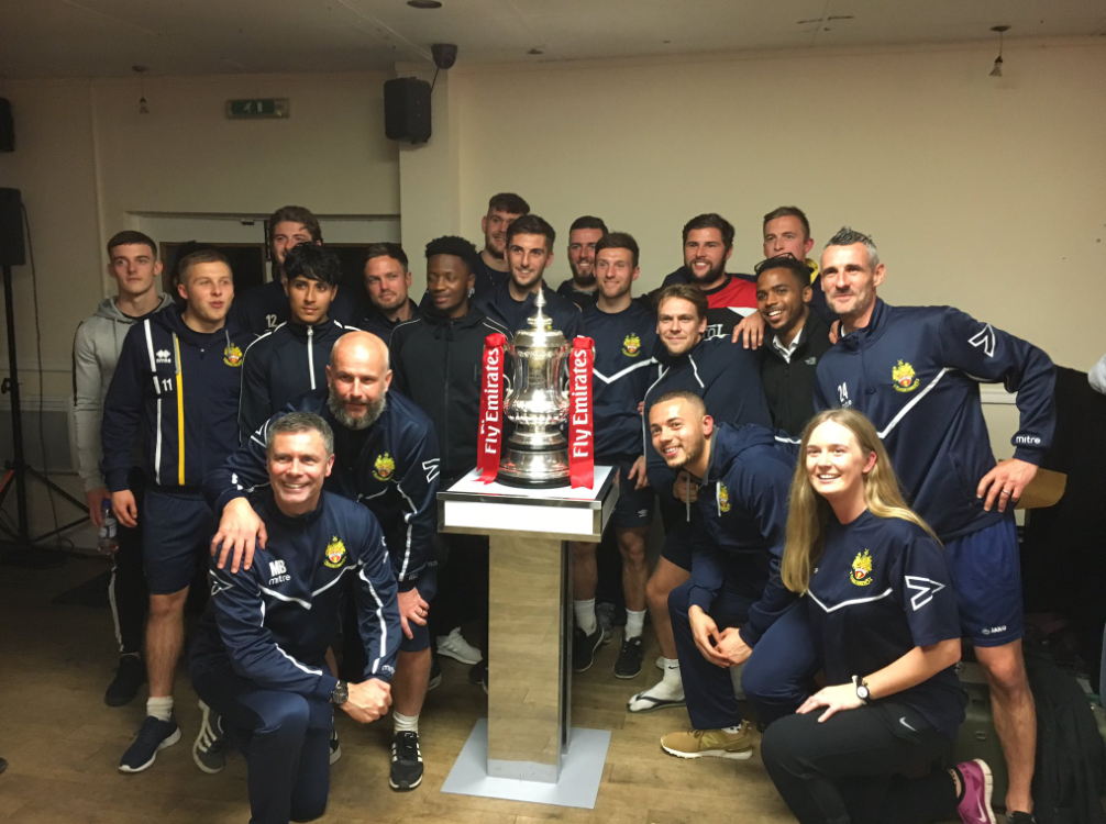 Hitchin players and members pose with the FA Cup (Getty)