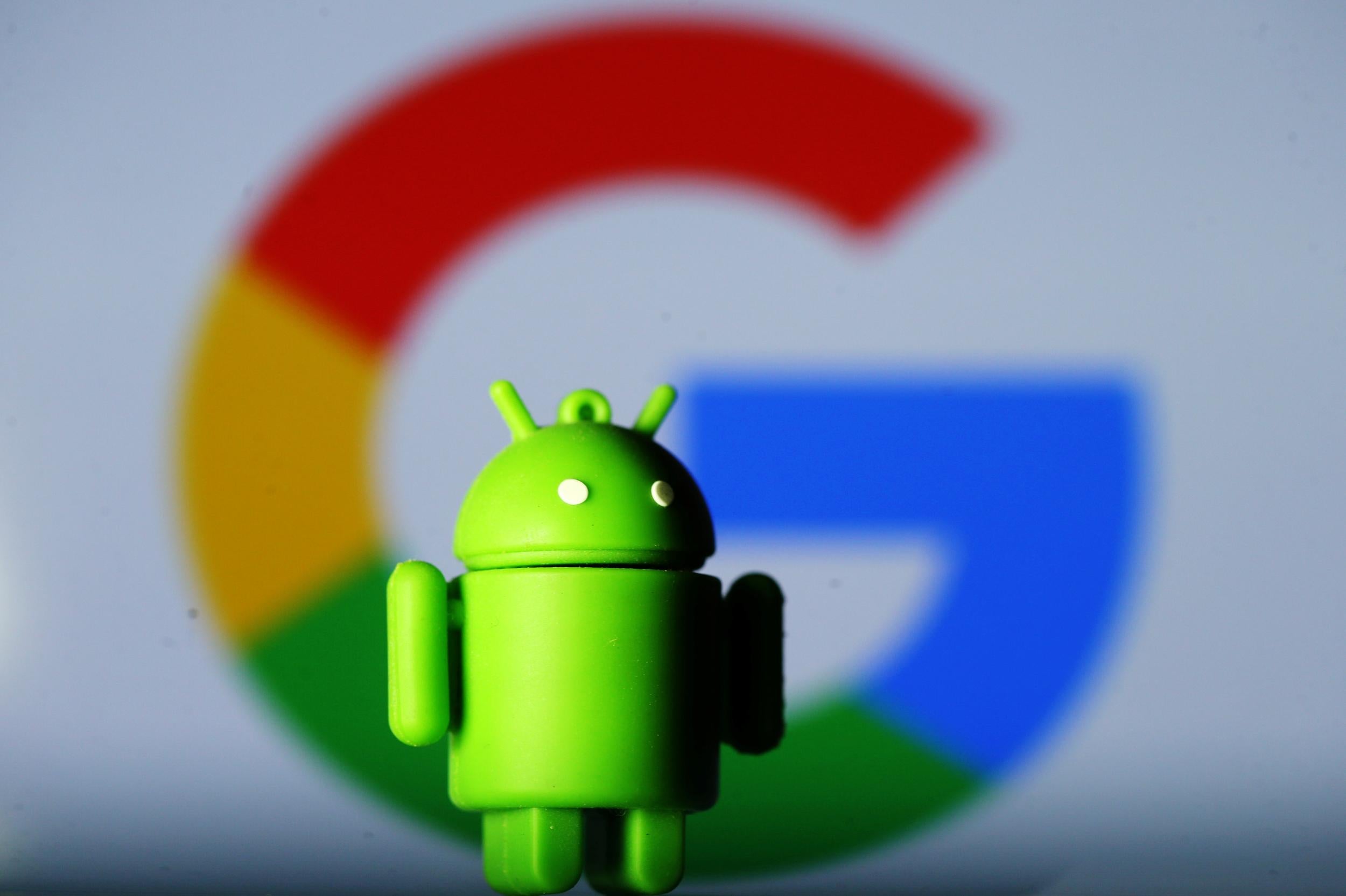 A 3D printed Android mascot Bugdroid is seen in front of a Google logo