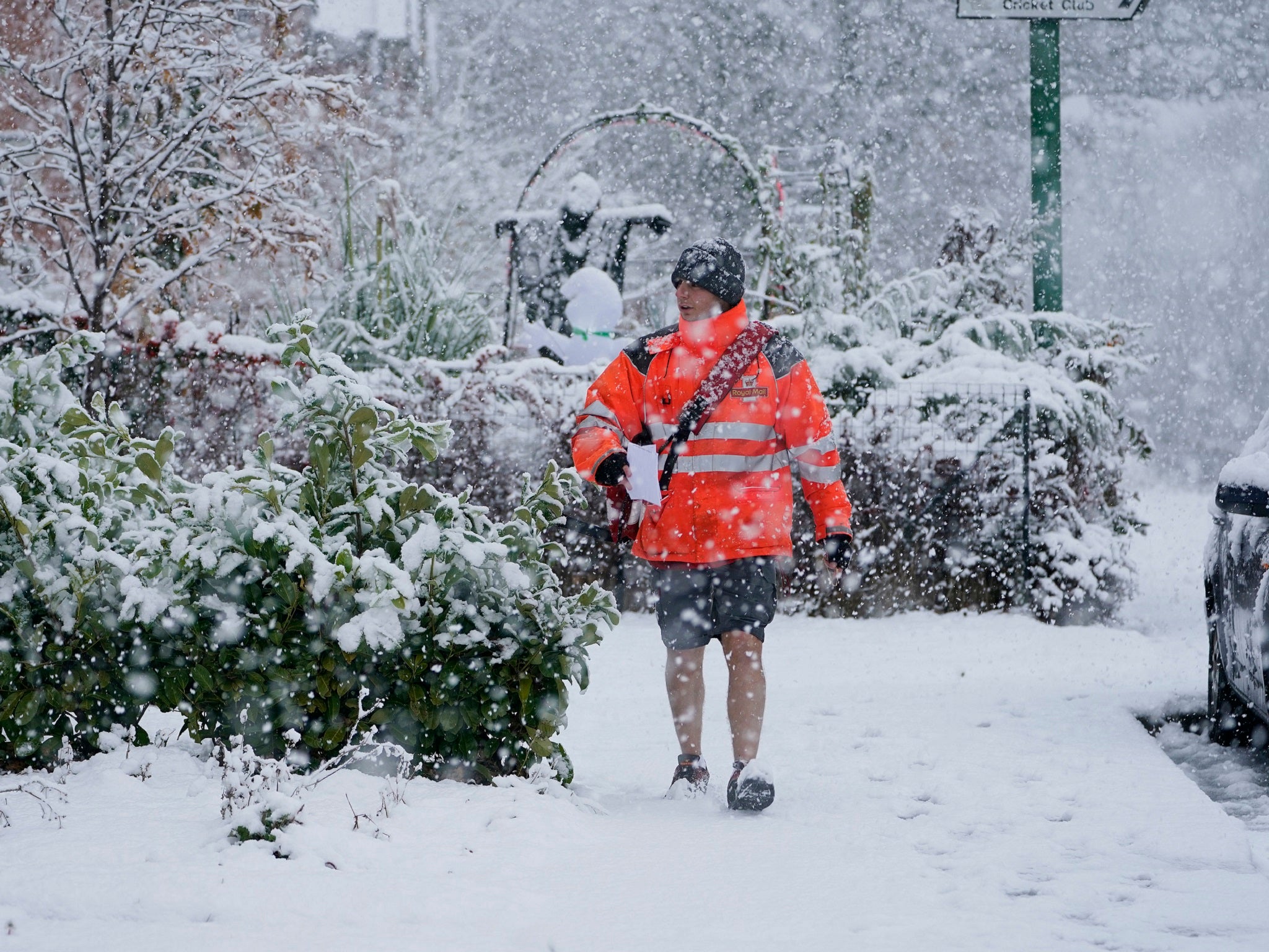 A postman in shorts delivers mail in the snow near Consett, County Durham, Saturday, 27 October, 2018.