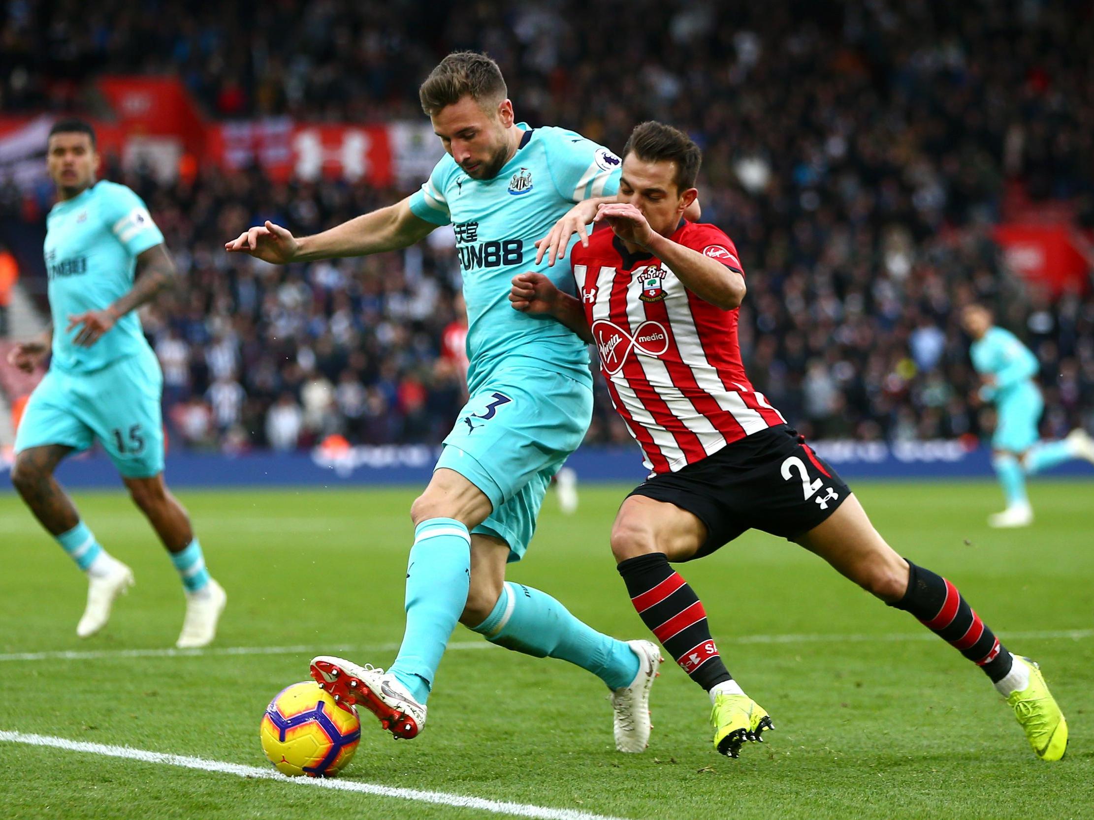 Paul Dummett and Cedric Soares tussle for possession