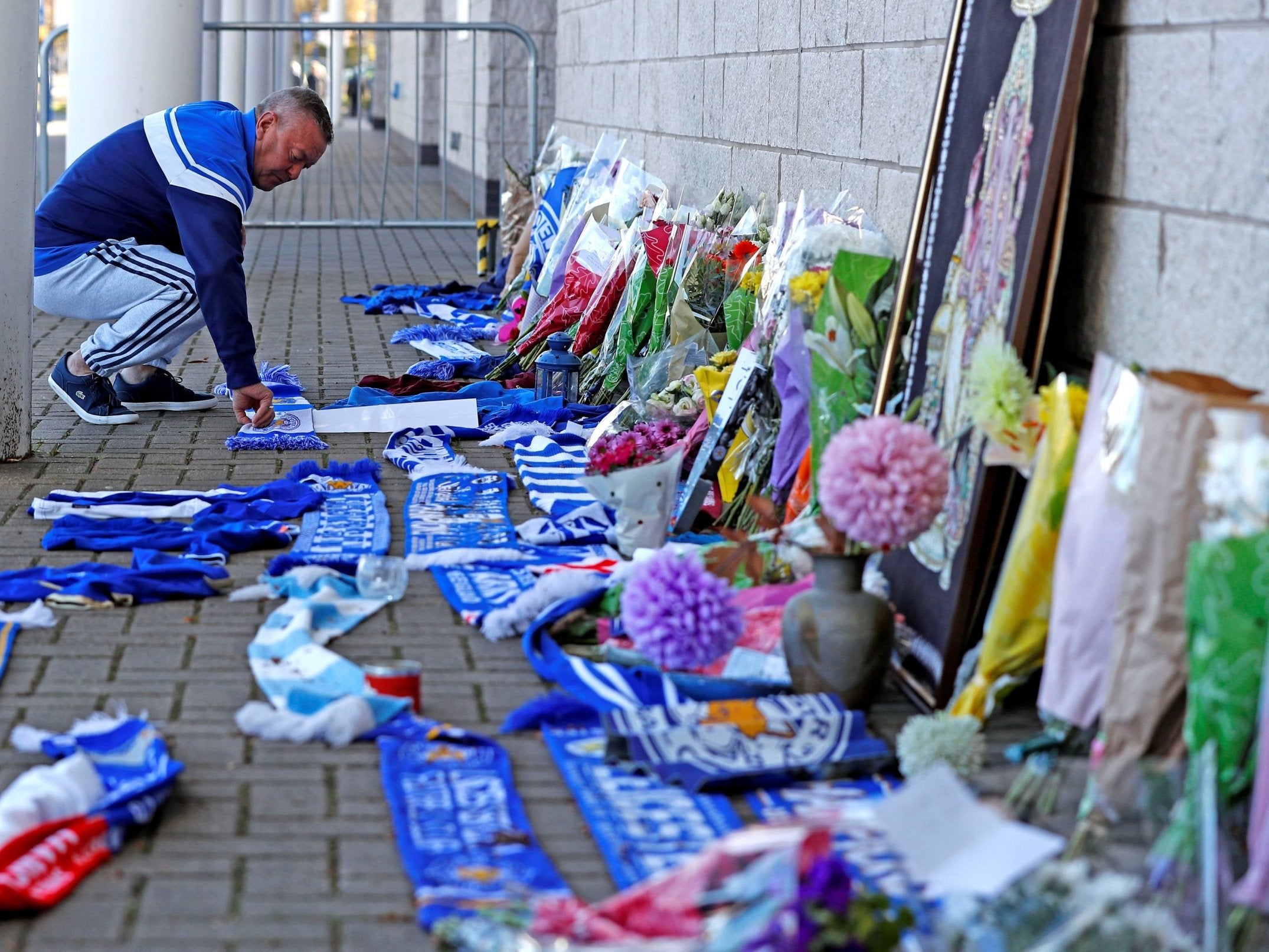 Flowers and scarves outside the stadium (Reuters/Peter Nicholls)