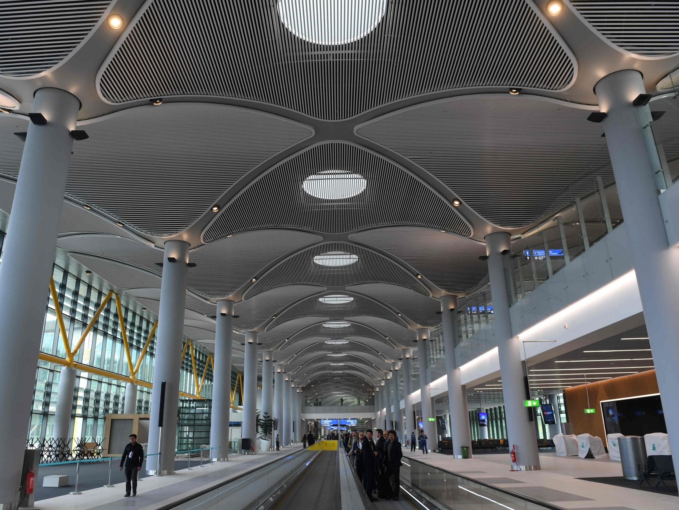 Visitors and workers are seen in the new airport building during a press tour of the Istanbul New Airport