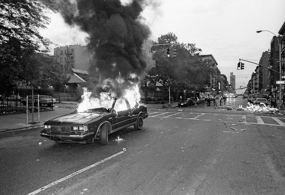 A car is set alight in the aftermath of the 1992 police killing of Jose ‘Kiko’ Garcia