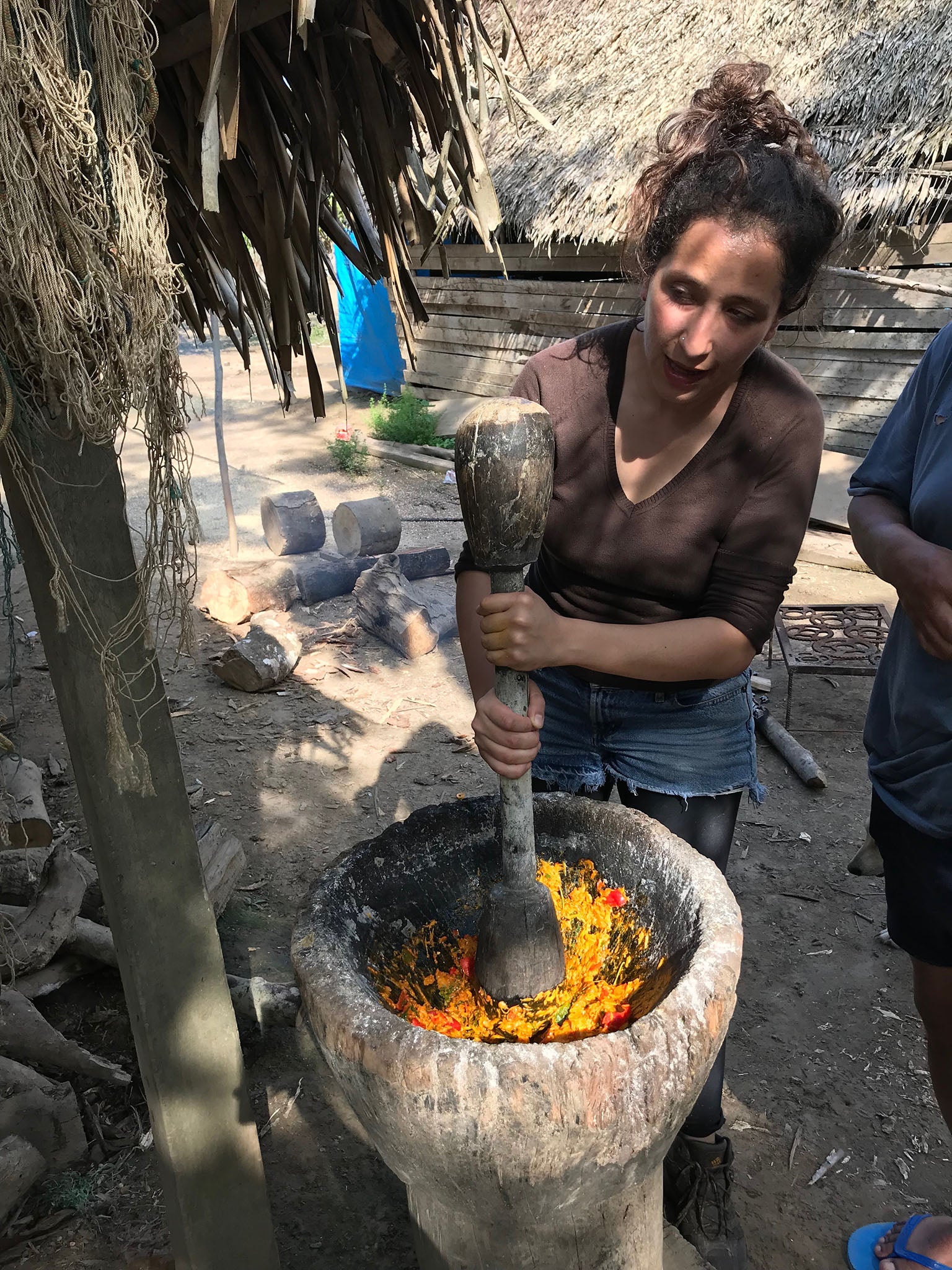 Chef Taha mashes ingredients for a fish curry