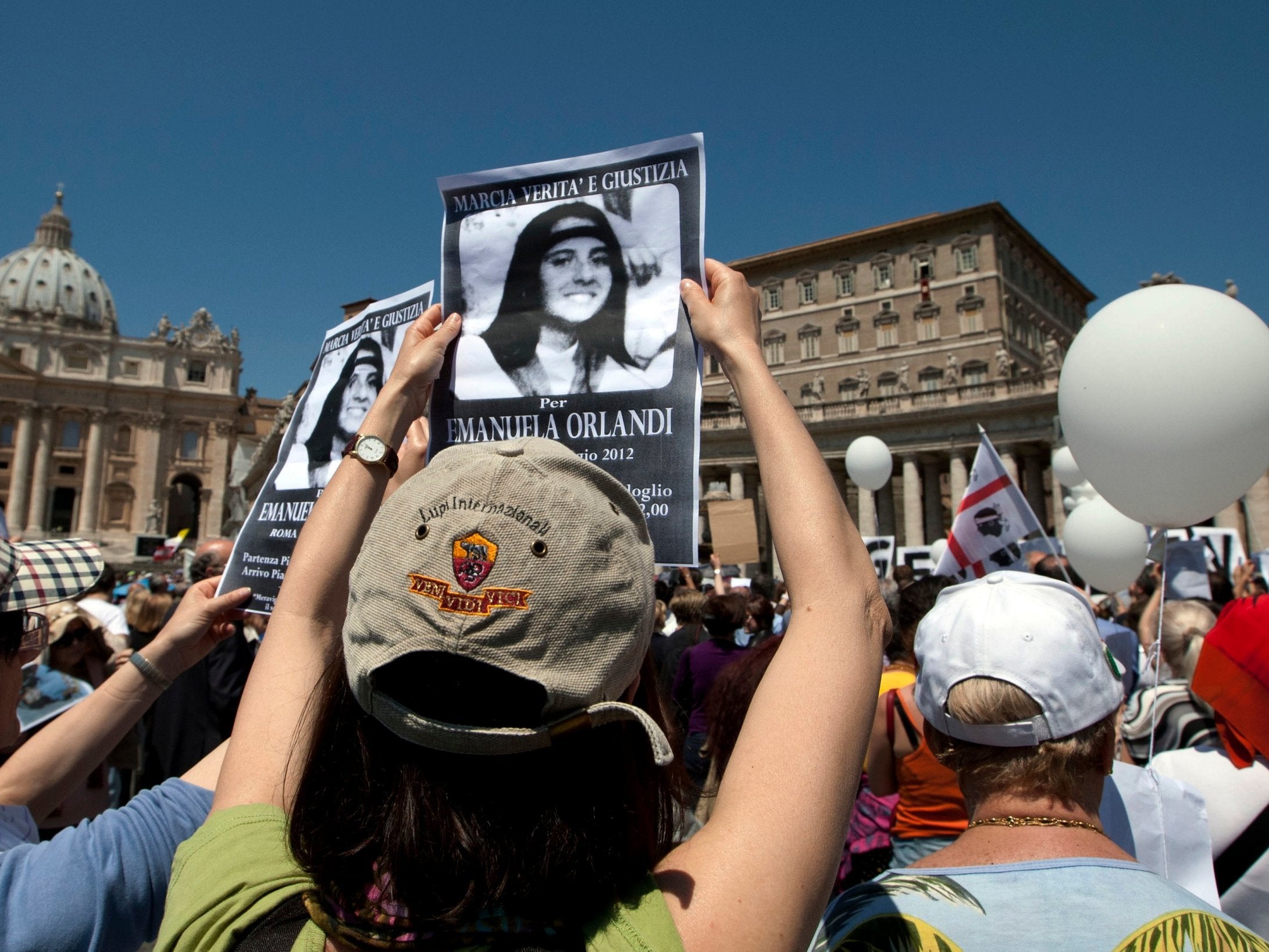 Demonstrators hold pictures of Emanuela Orlandi reading 'march for truth and justice for Emanuela' during Pope Benedict XVI's Regina Coeli prayer in St Peter's square, at the Vatican, in 2012