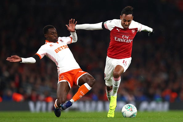 Arsenal edged past ten-man Blackpool in the fourth round