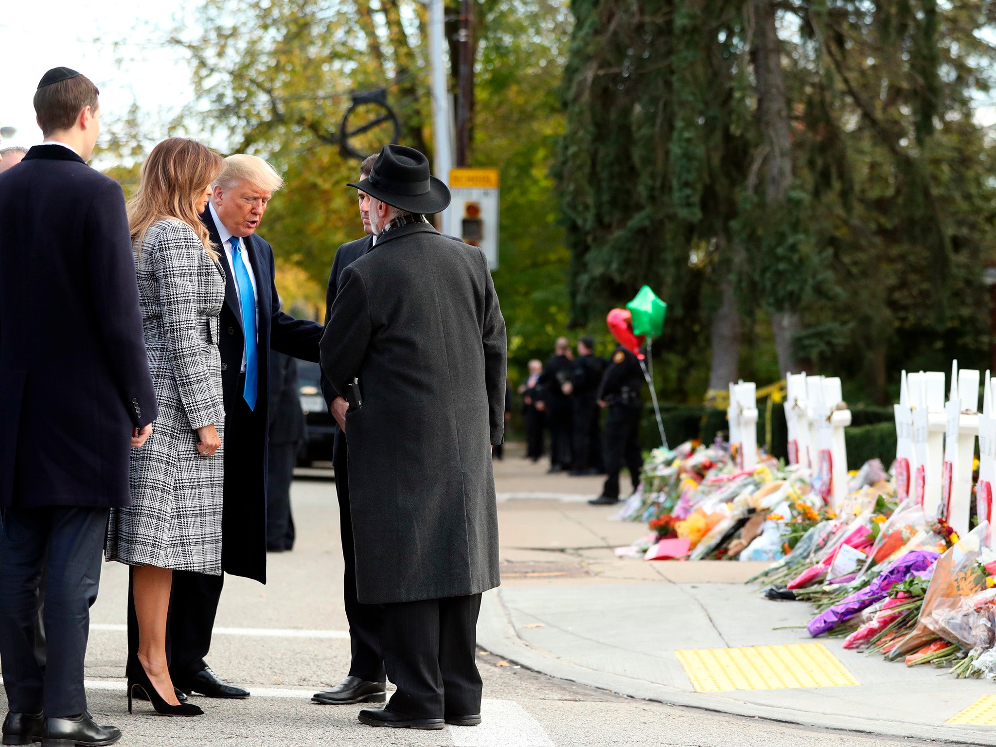 Donald Trump and Melania Trump talk with Rabbi Jeffrey Myers (back to camera) and Ron Dermer, Israel's ambassador to the United States, outside Pittsburgh's Tree of Life Synagogue in Pittsburgh