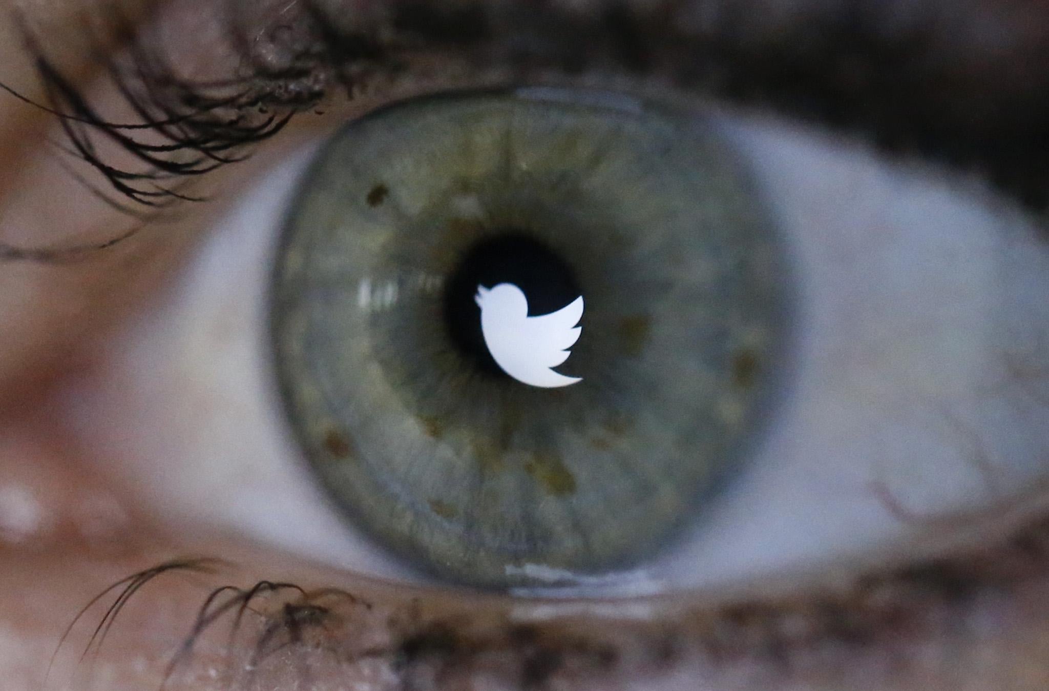 An illustration picture shows the Twitter logo reflected in the eye of a woman in Berlin