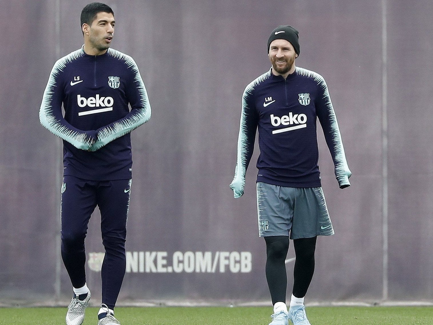 Messi and Barcelona teammate Luis Suarez attend a training session