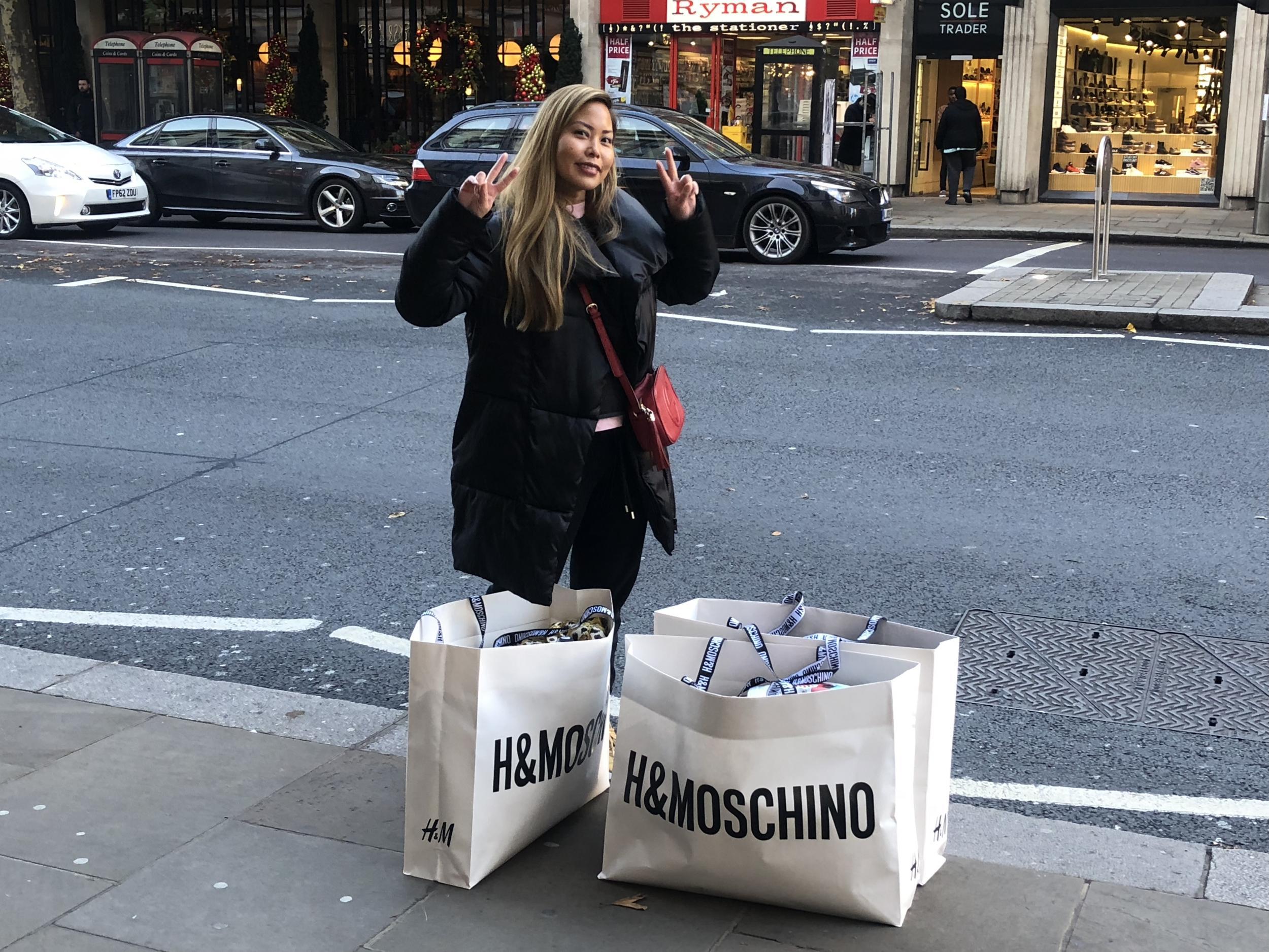 A pleased shopper pictured with her purchases outside the High Street Kensington store.