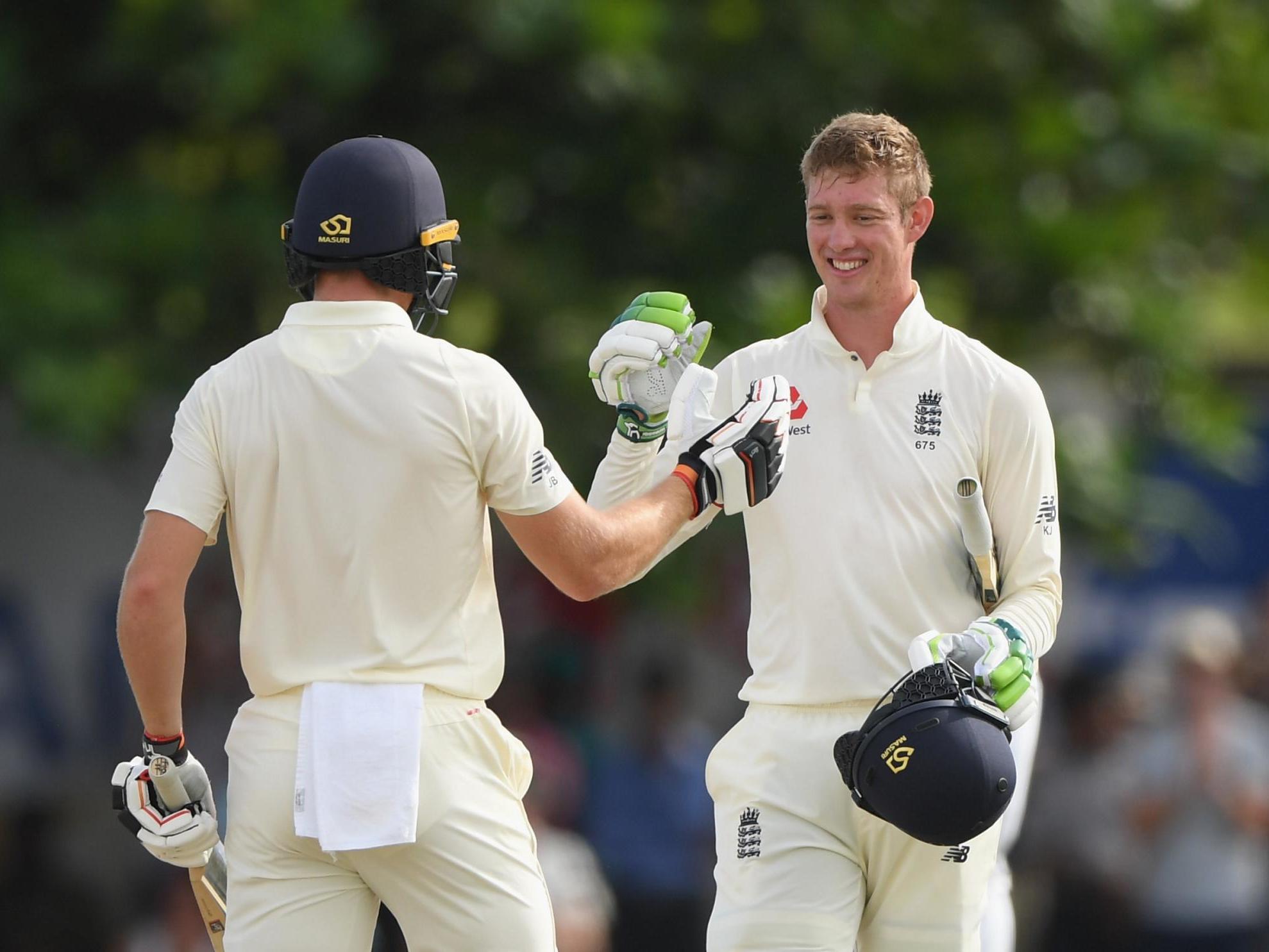 Jennings celebrates with Jos Buttler after reaching his century