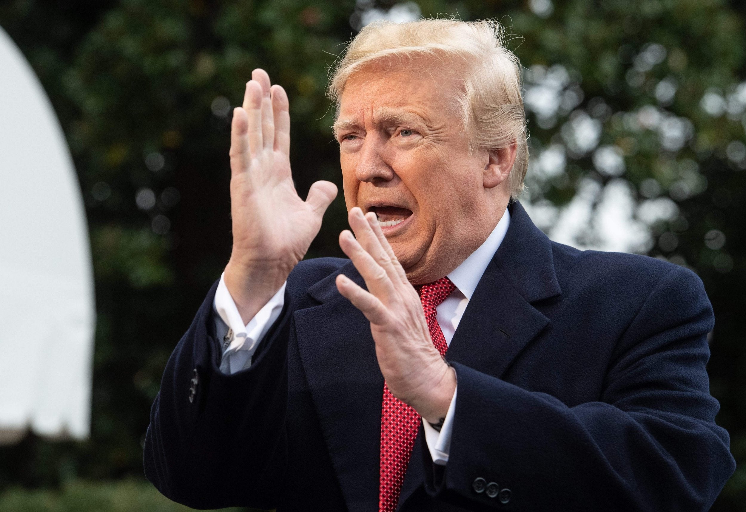 Donald Trump speaks to the press before departing the White House for Paris in November 2018