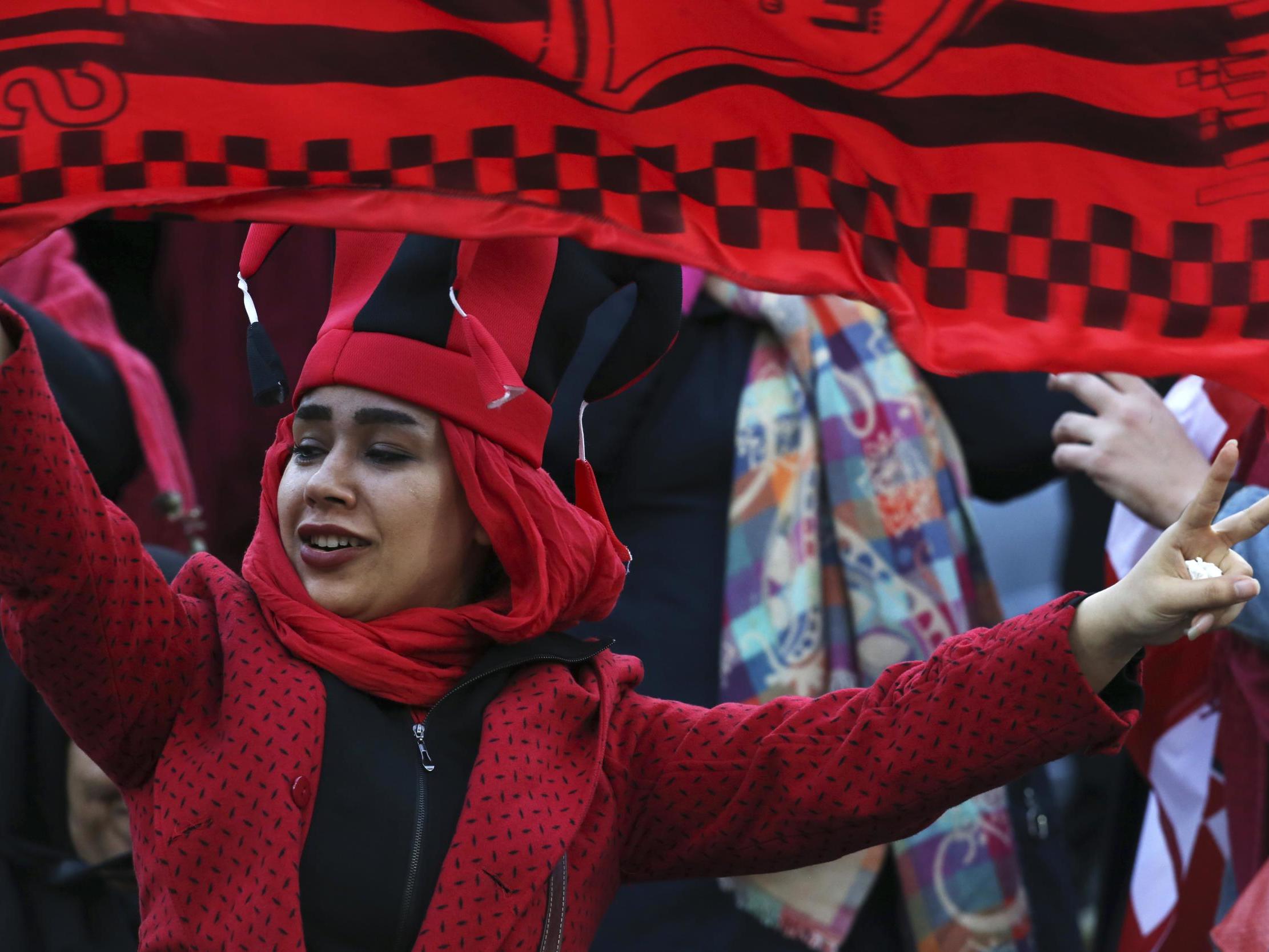 A woman football fan - one of about 500 there - supports her team