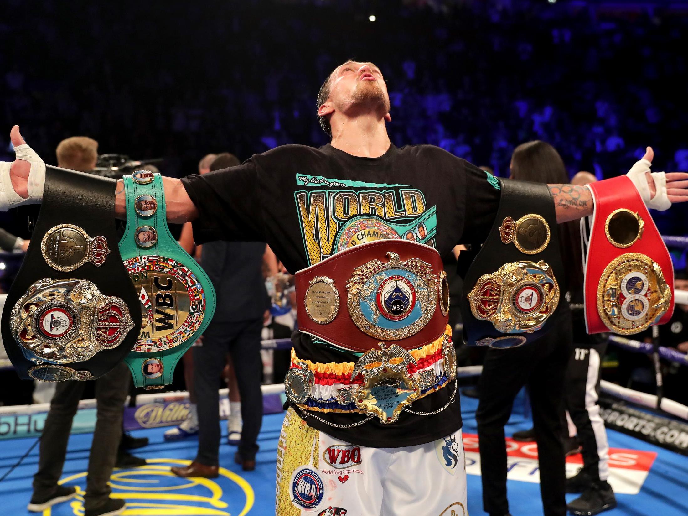 Oleksandr Usyk celebrates after remaining the unified cruiserweight champion